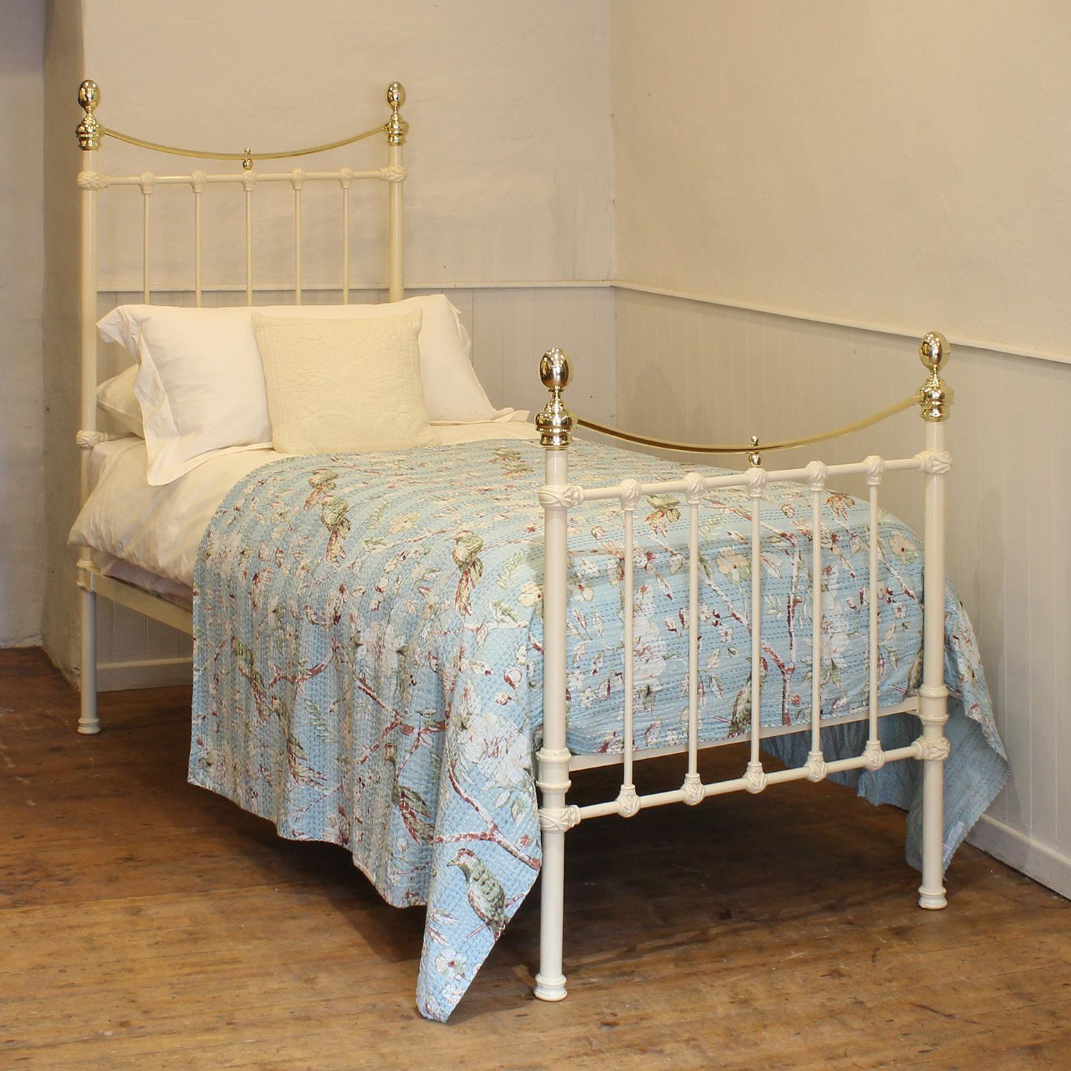 A traditional single Victorian brass and iron antique bed in cream, with curved brass top rail, brass collars and oval knobs.
This fine original antique bed from the late Victorian era has attractive castings,.
This bed takes a standard UK single