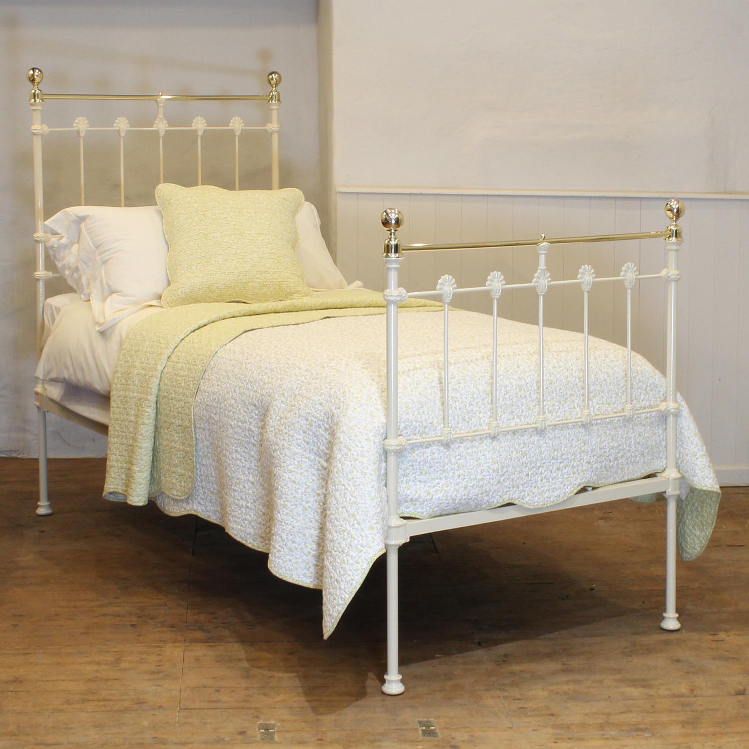 A traditional single Victorian brass and iron antique bed in cream, with straight brass top rail, brass collars and round knobs.
This fine original antique bed from the late Victorian era has attractive castings,.
This bed takes a standard UK single
