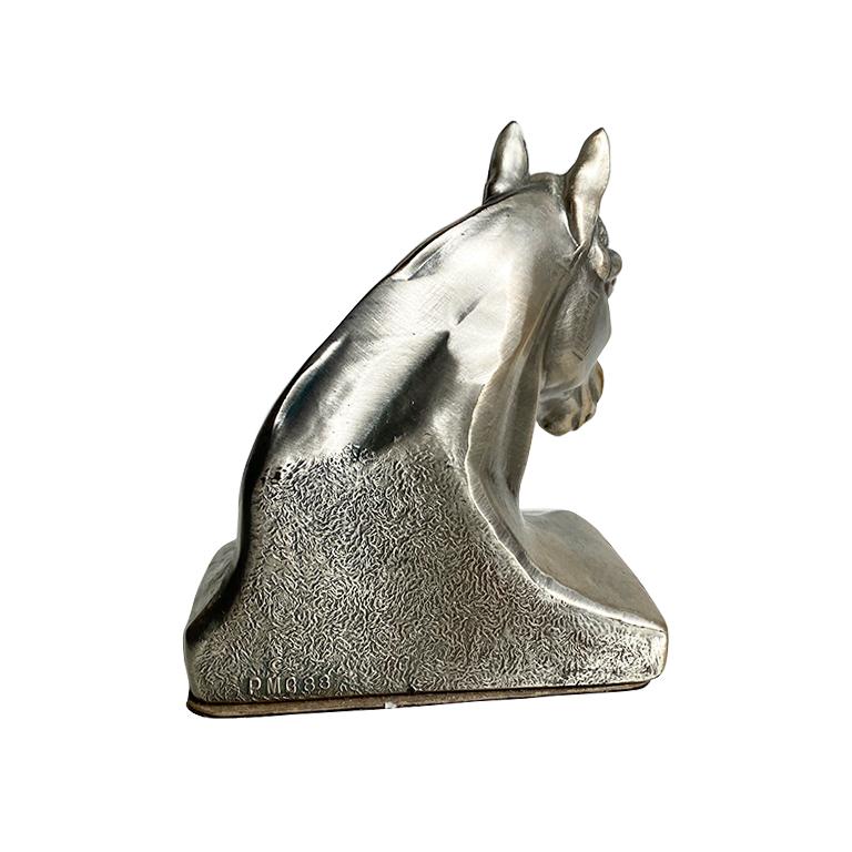 A traditional style solid brass bookend of a horse bust. For the traditional lover, this heavy bookend will add a hint of equine sentiment to any bookshelf. The piece depicts the bust of a horse, with its snout facing outwards. He has a long flowing