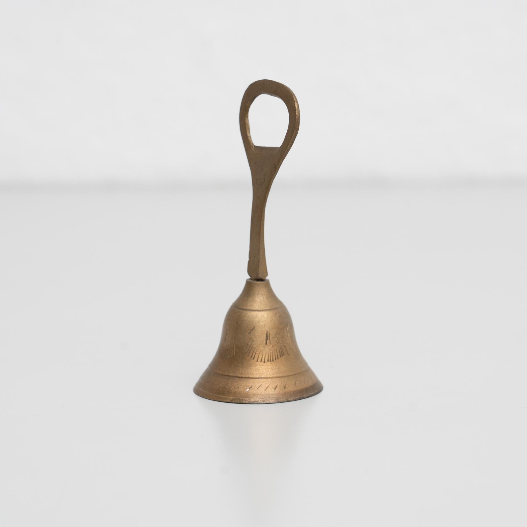 Traditional rustic metal hand bell bottle opener, by unknown manufacturer from Spain, circa 1950.

In original condition, with minor wear consistent with age and use, preserving a beautiful patina.

Materials:
Metal.
 