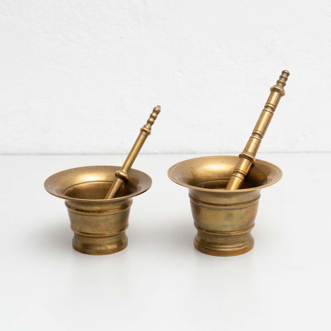 Set of two vintage metal mortar and pestile. 

Made by unknown manufacturer in Spain circa 1950.

In original condition, with minor wear consistent with age and use, preserving a beautiful patina.

Materials:
Metal.
 