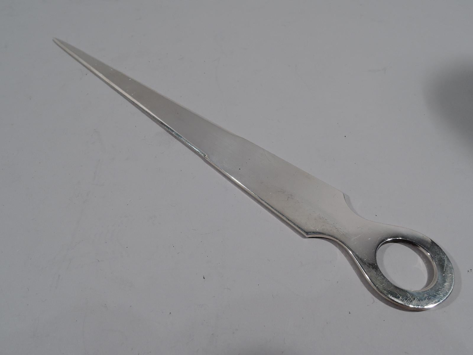 Traditional sterling silver letter opener. Retailed by Tiffany & Co. in New York. Flat and tapering pointed blade and oval ring handle. Marked “Tiffany & Co. / Sterling / Reproduction / 3”. Weight: 1.8 troy ounces.