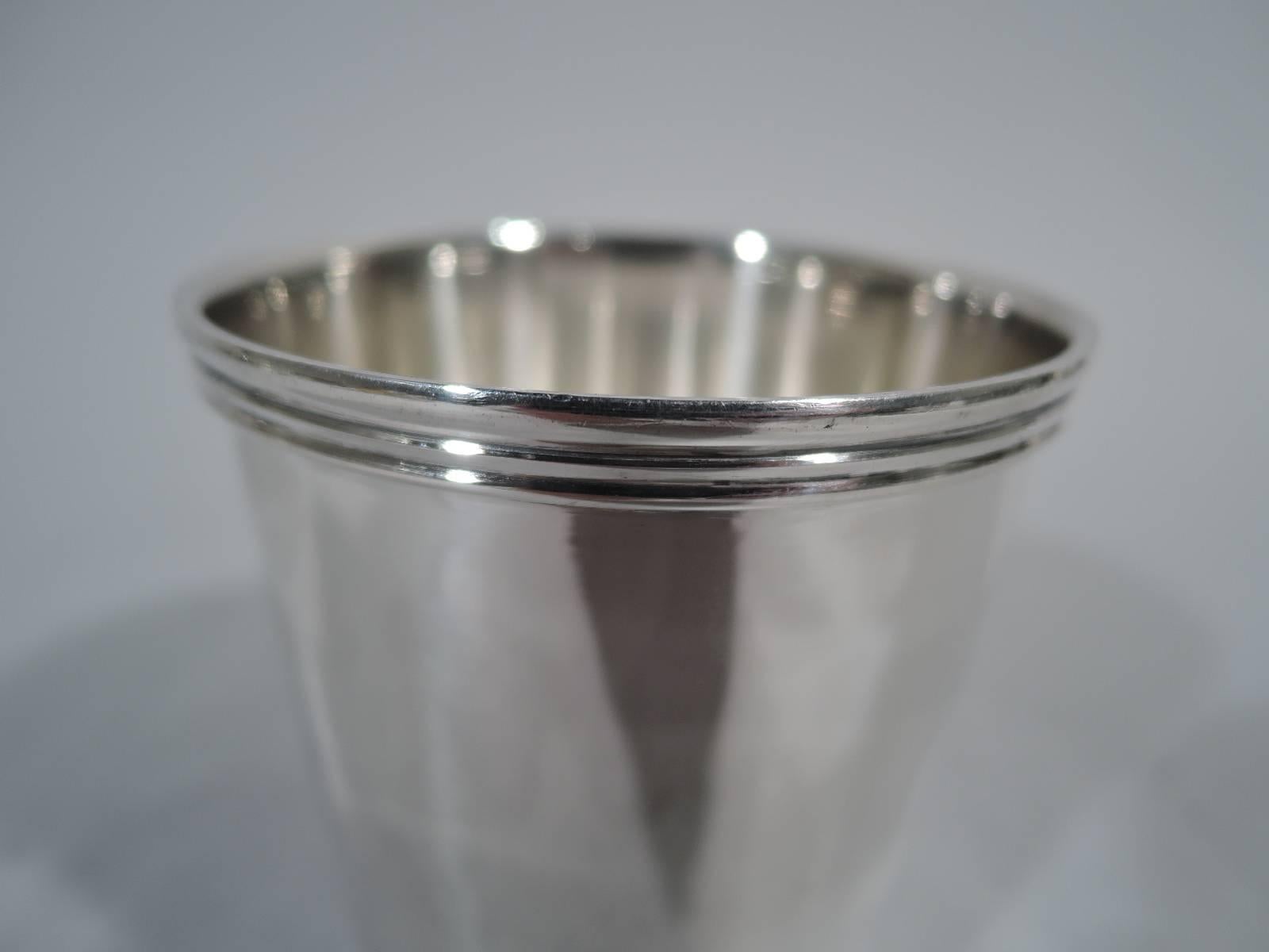 Traditional sterling silver mint julep cup. Straight and tapering sides and reeded rim and foot. Hallmarked Ensko, a New York maker that specialized in historic reproductions. Weight: 4.4 troy ounces.