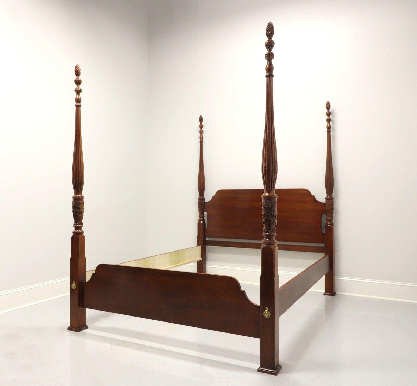A Traditional style queen size rice bed, unbranded, similar quality to Drexel. Hardwood with cherry finish, four rice carved motif posts with finials and brass covers to footboard. Three wood slats rest on side rails for mattress support. Side rails