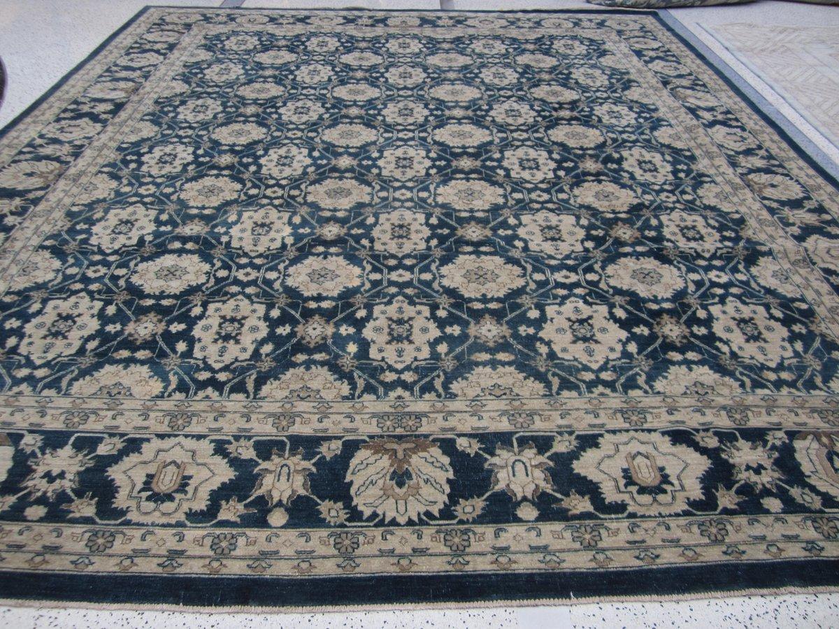 Elegant wool area rug with all-over design in blue and beige. Hand knotted in Pakistan.