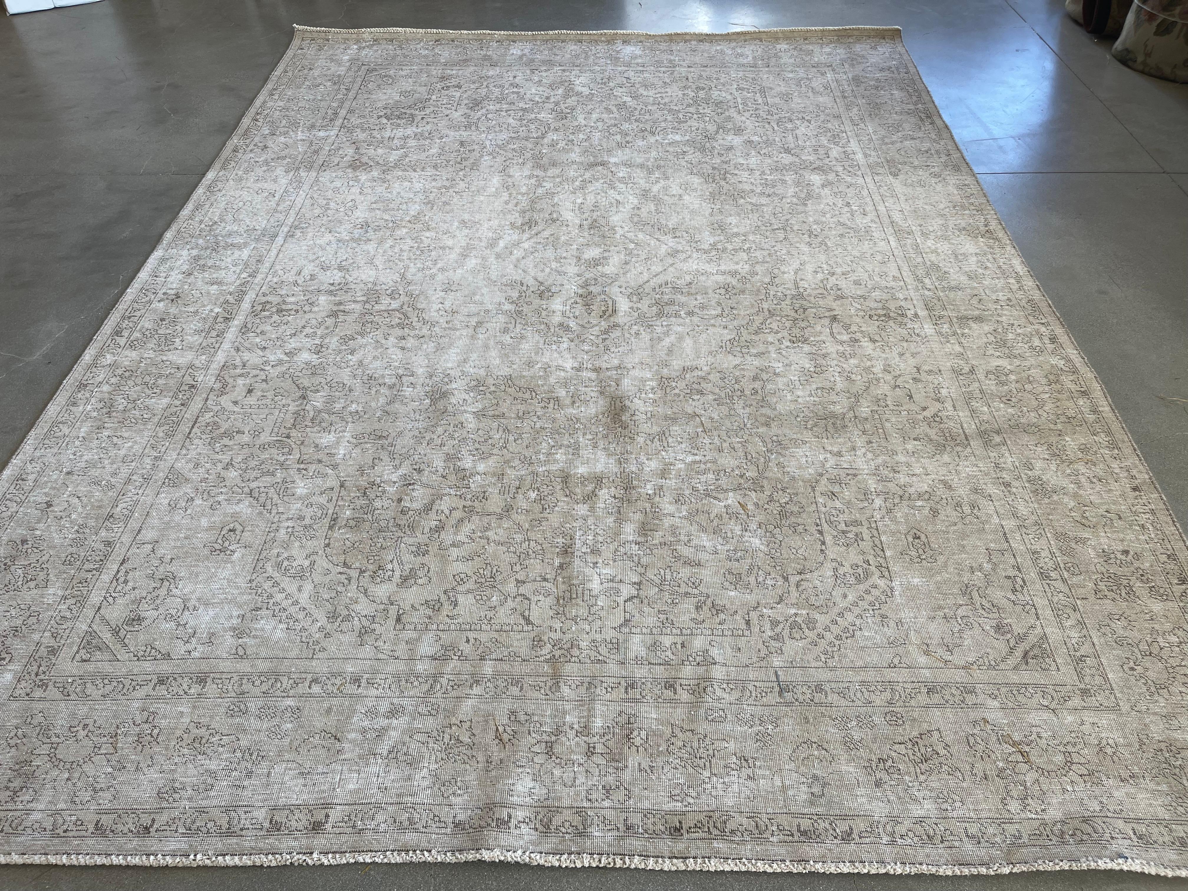 The traditional look receives a modern makeover in this transition rug from Pakistan featuring a large center panel with floral motif and wide outer frame. A meticulous shearing technique creates a one-of-a-kind distressed piece, removing pile but