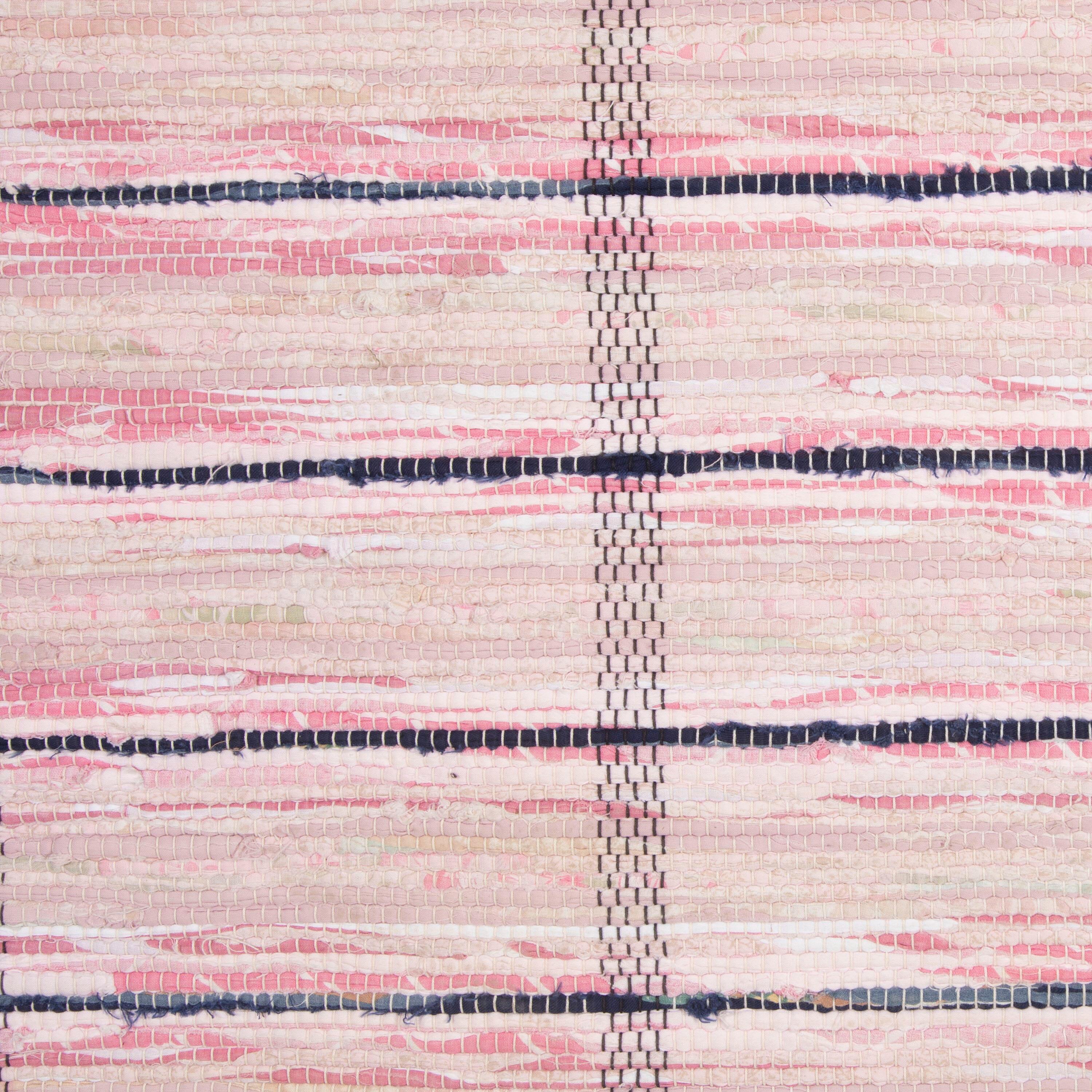 Swedish traditional rag rug in tones of pink, and ecru with a wide striped design throughout. 
This rug has long proportions, ideal for use within a hallway or corridor. It features a dense pattern in a range of colours that have mellowed