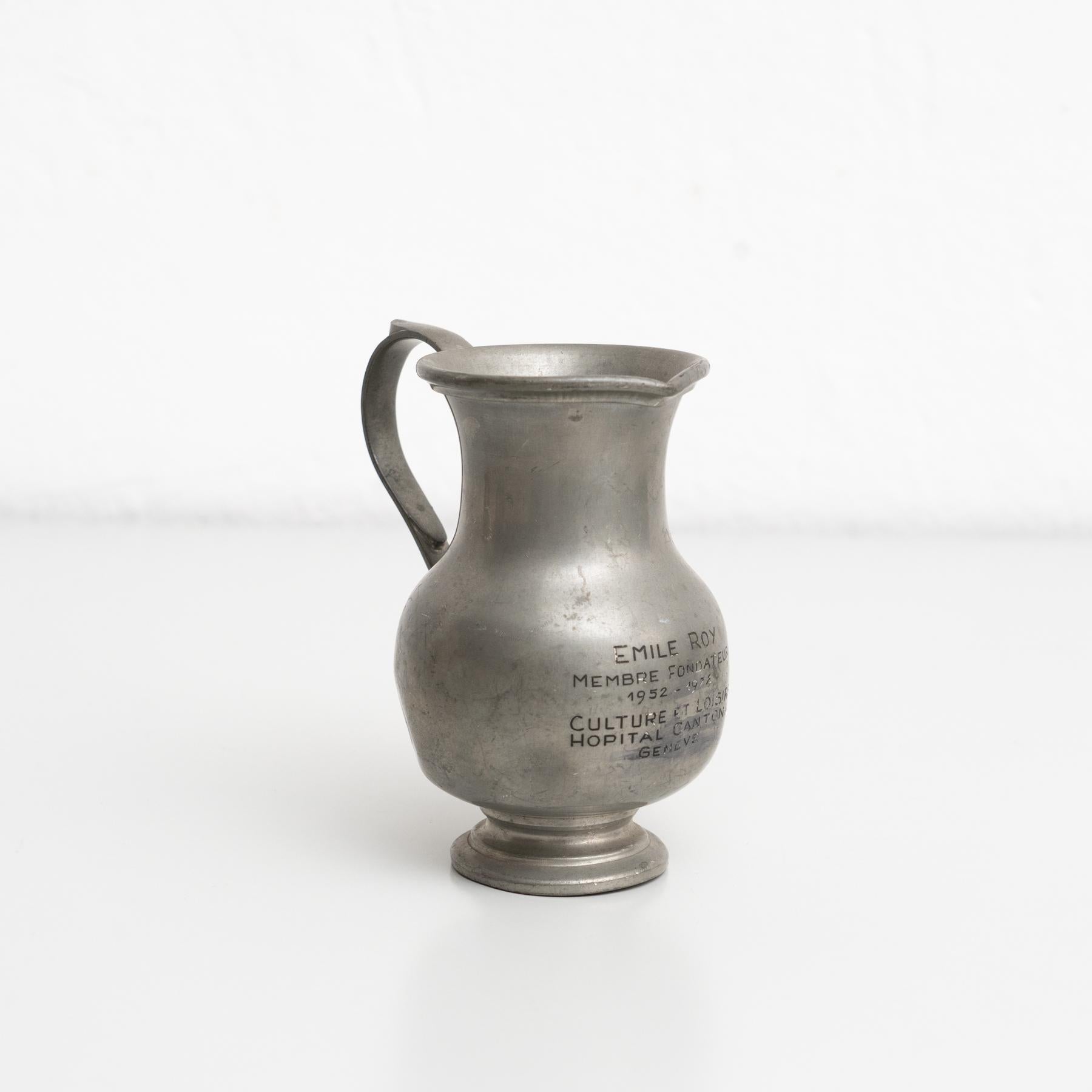 Vintage metal commemorative metal jug.    By unknown manufacturer, made in Switzerland circa 1970.    In original condition, with minor wear consistent with age and use, preserving a beautiful patina.    Materials:  Metal.   