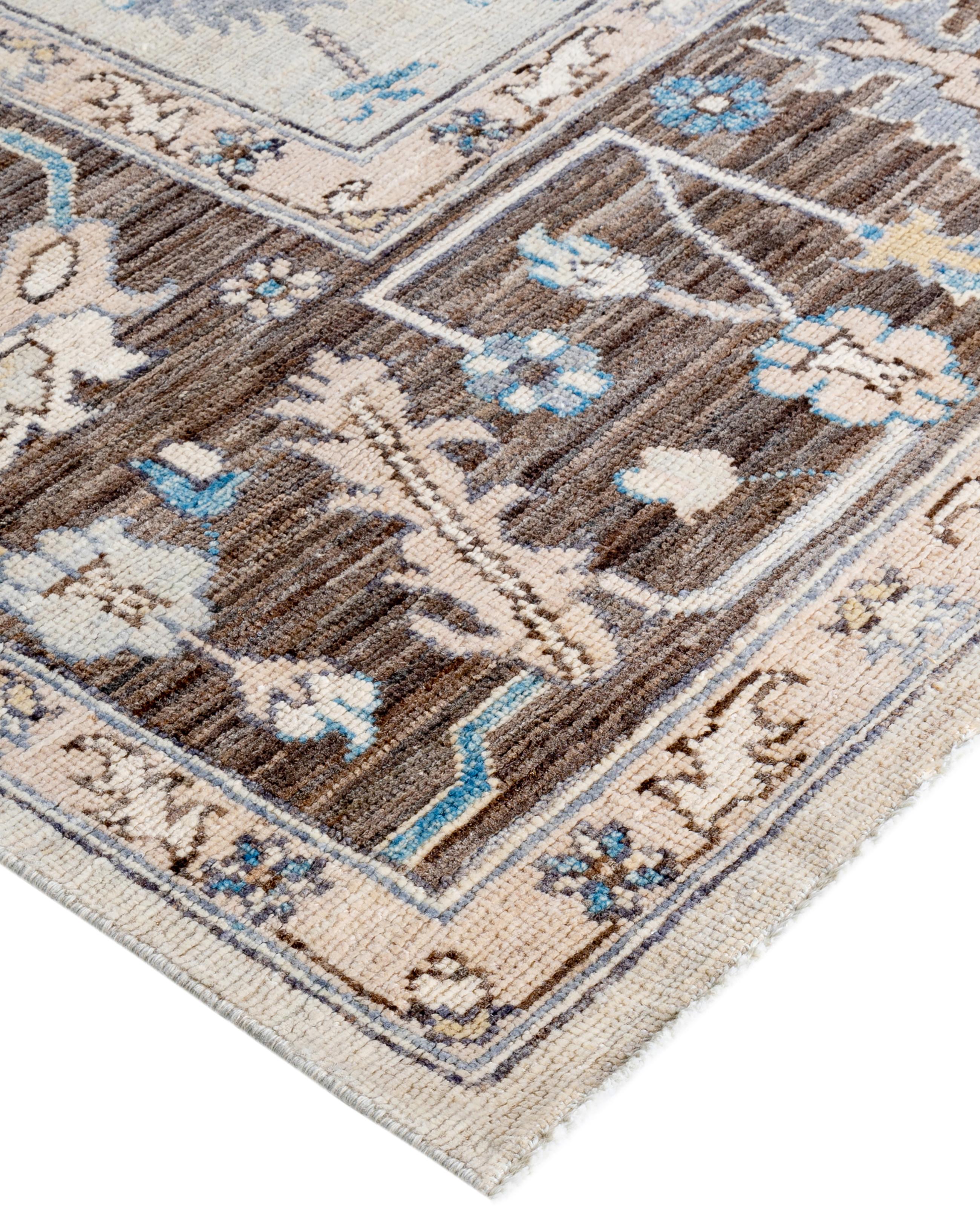 Oushak rugs are known for their soft, muted color palettes and large-scale, flowing designs. They often feature soft tones like beige, cream, gold, and light blue, with motifs that include palmettes, vines, and geometric shapes. These rugs are