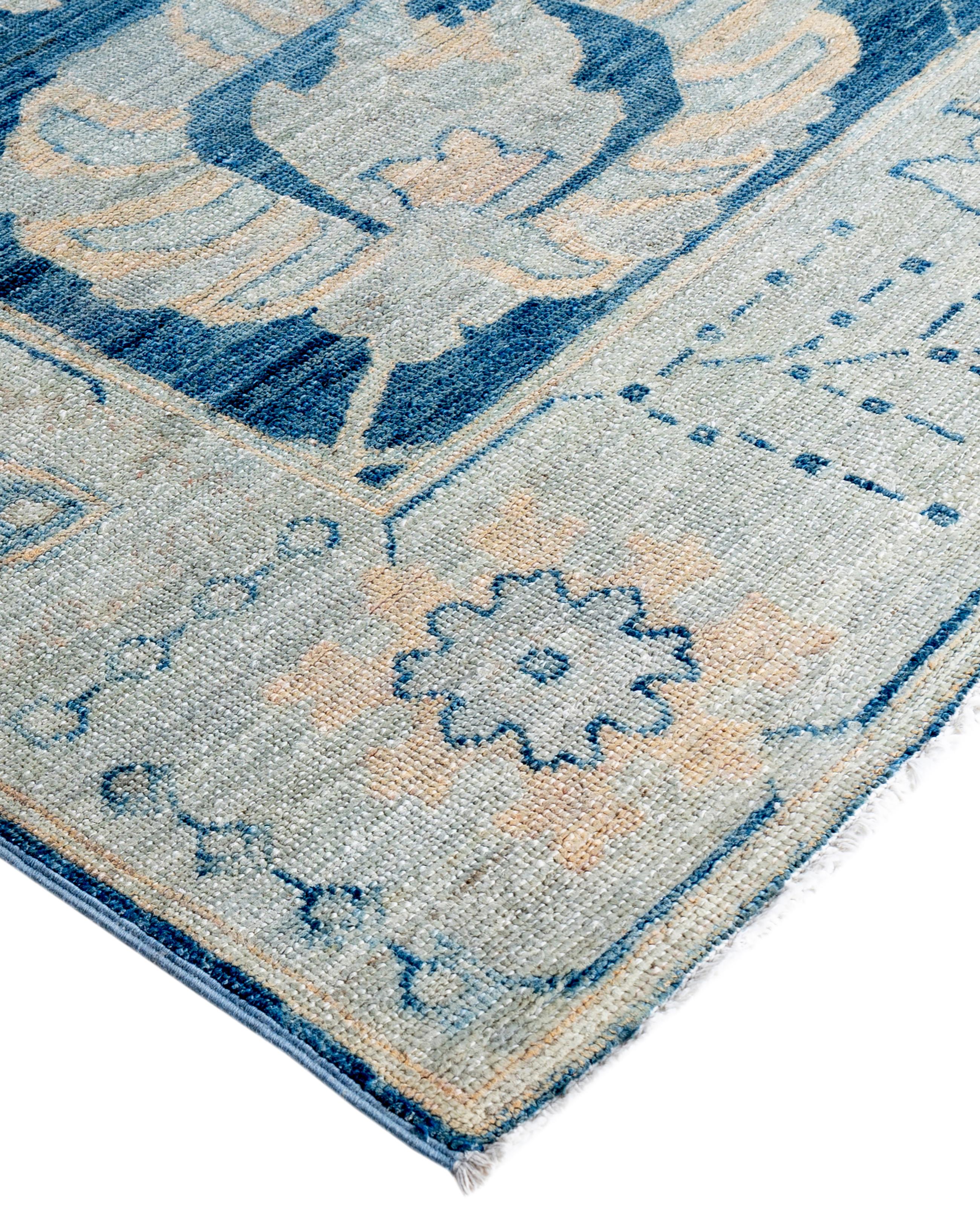 Oushak rugs are known for their soft, muted color palettes and large-scale, flowing designs. They often feature soft tones like beige, cream, gold, and light blue, with motifs that include palmettes, vines, and geometric shapes. These rugs are