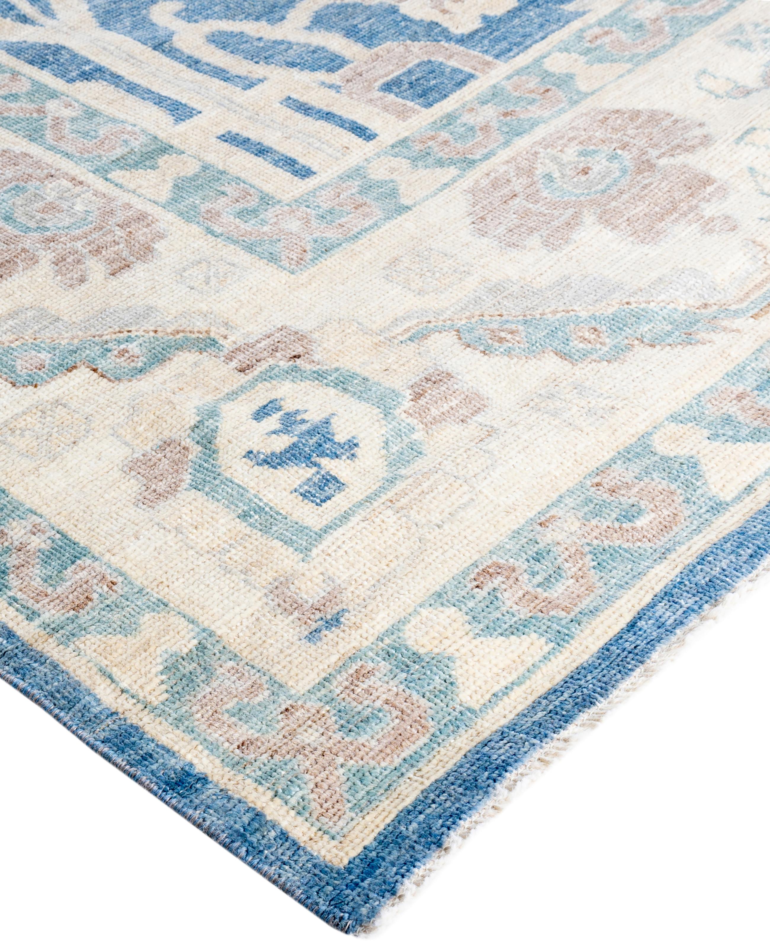 Oushak rugs are known for their soft, muted color palettes and large-scale, flowing designs. They often feature soft tones like beige, cream, gold, and light blue, with motifs that include palmettes, vines, and geometric shapes. These rugs are