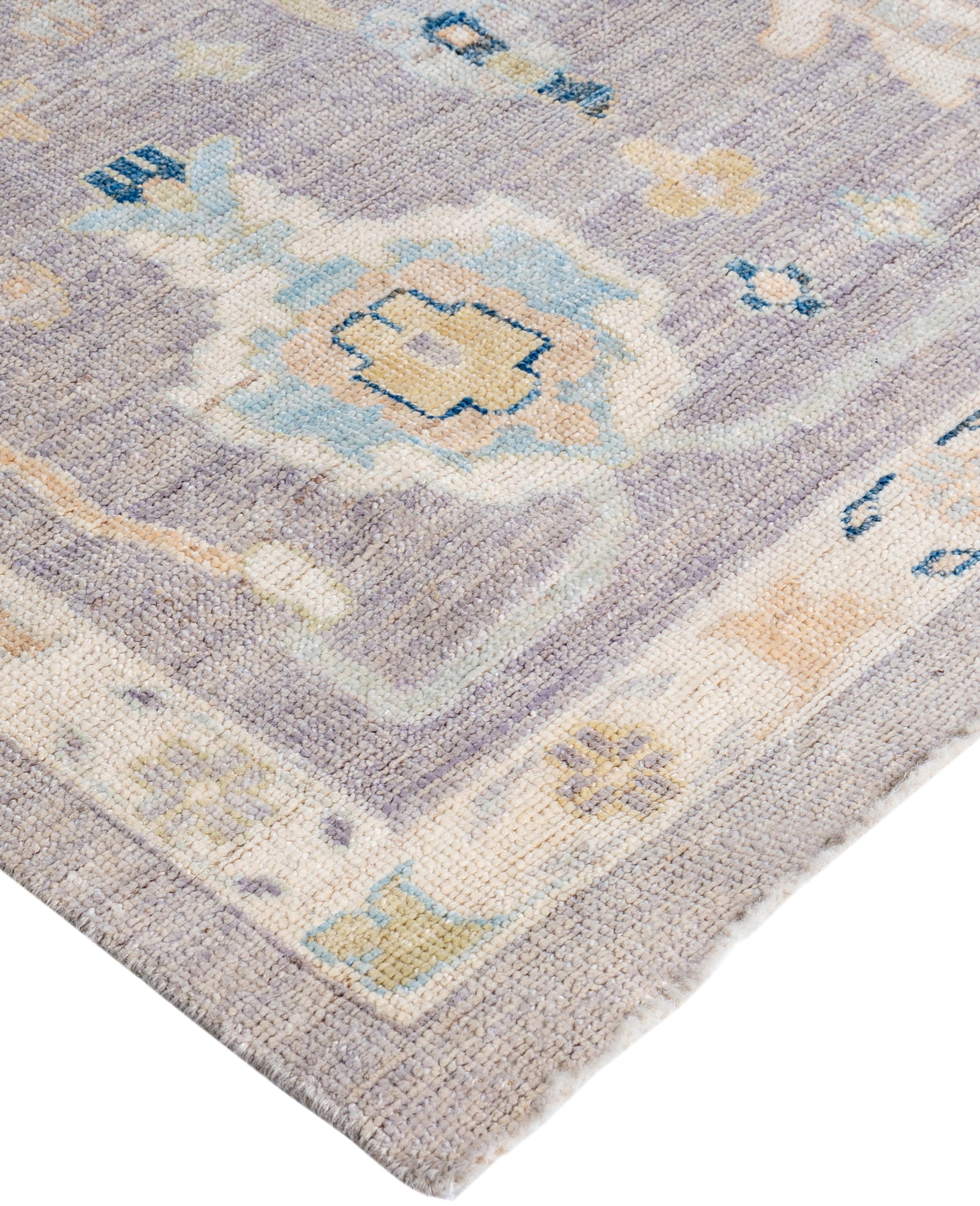 Oushak rugs are known for their soft, muted color palettes and large-scale, flowing designs. They often feature soft tones like beige, cream, gold, and light blue, with motifs that include palmettes, vines, and geometric shapes. These rugs are