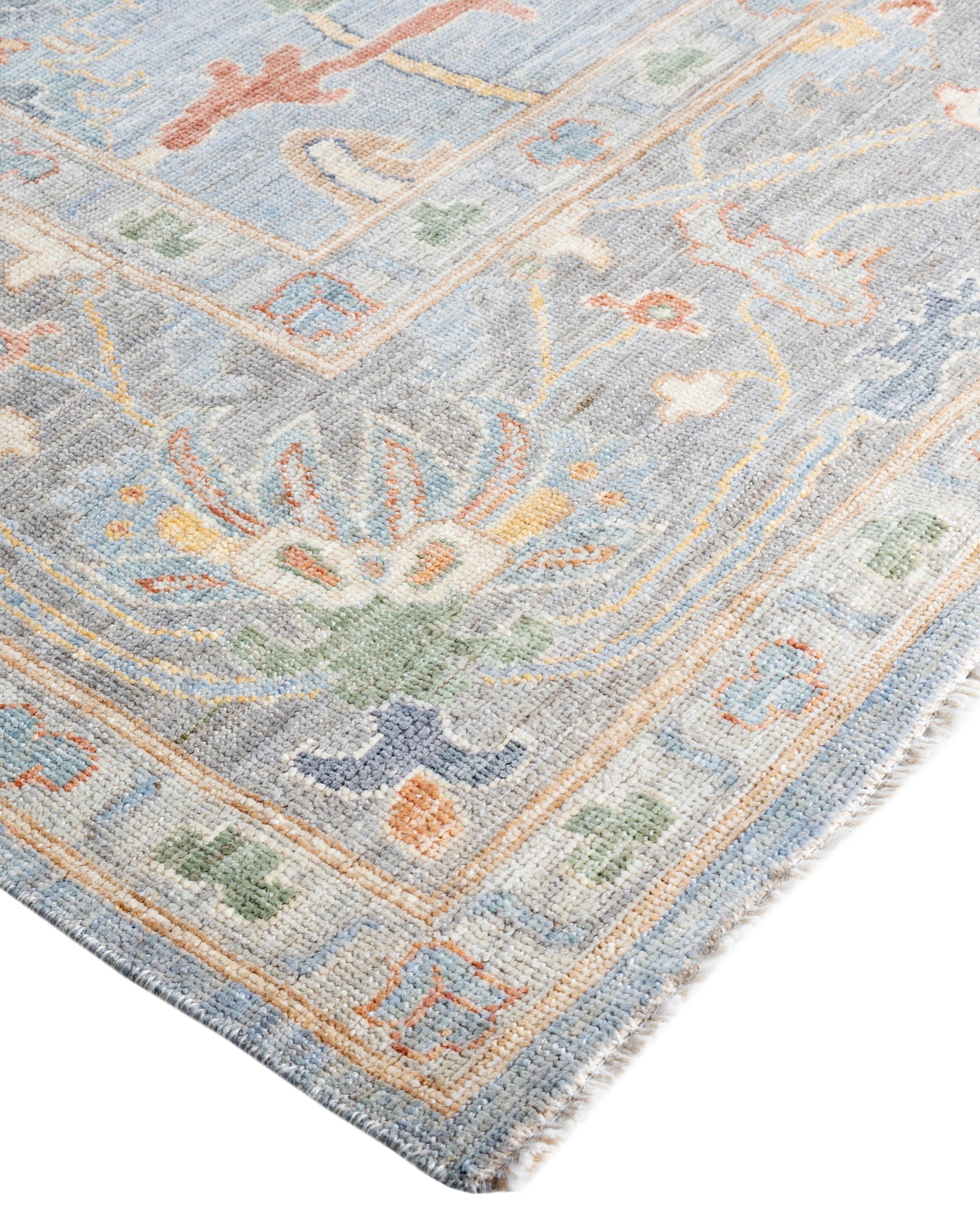 Oushak rugs are known for their soft, muted color palettes and large-scale, flowing designs. They often feature soft tones like beige, cream, gold, and light blue, with motifs that include palmettes, vines, and geometric shapes. These rugs are