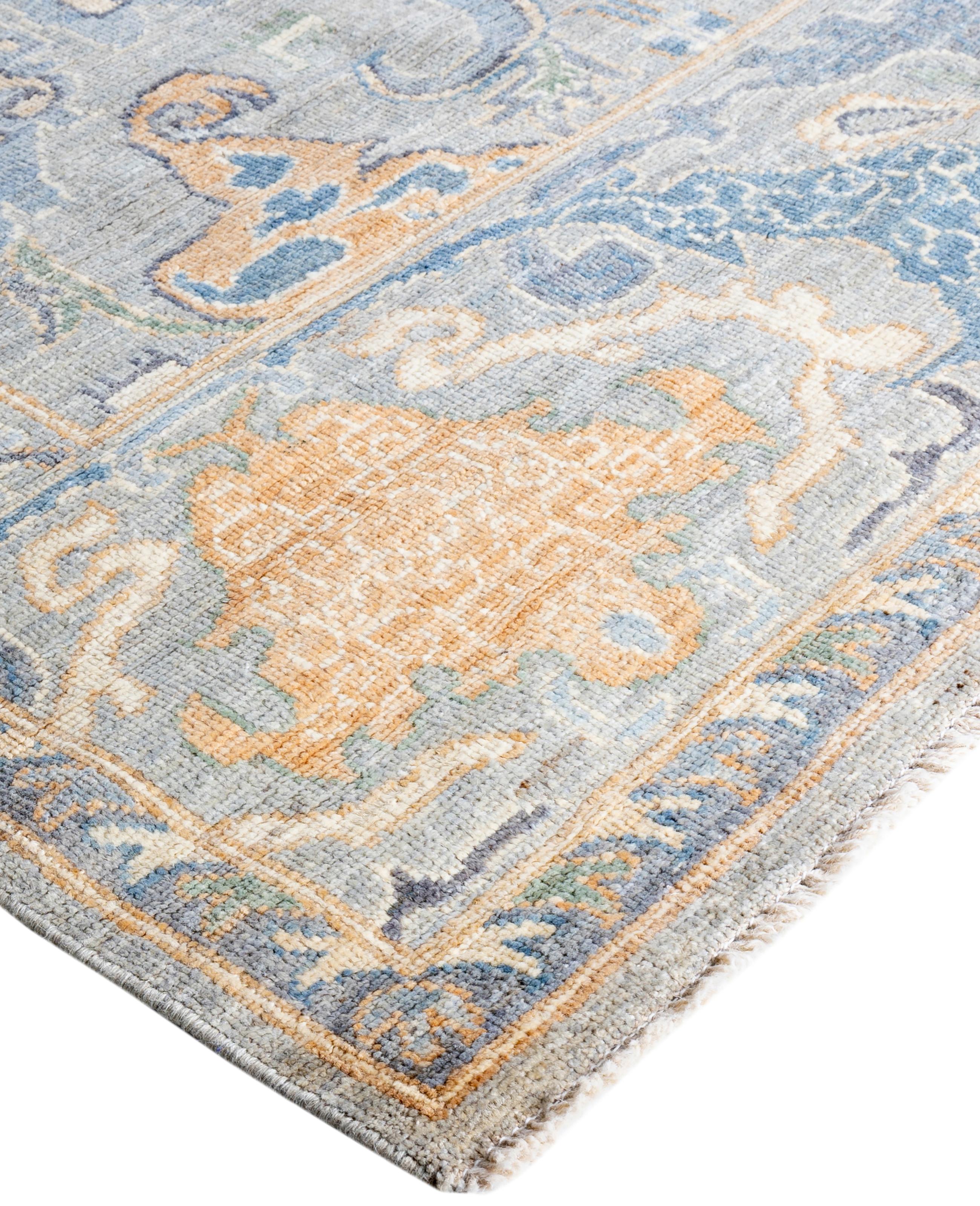Oushak rugs are known for their soft, muted color palettes and large-scale, flowing designs. They often feature soft tones like beige, cream, gold, and light blue, with motifs that include palmettes, vines, and geometric shapes. These rugs are