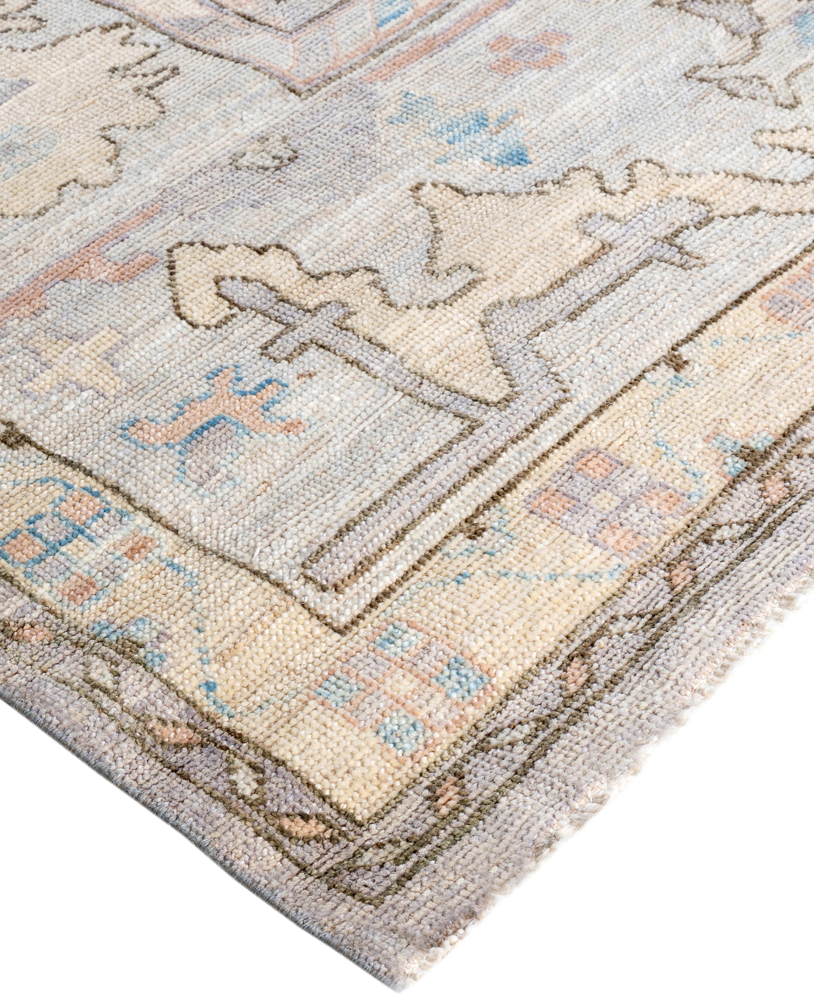 Oushak rugs are known for their soft, muted color palettes and large-scale, flowing designs. They often feature soft tones like beige, cream, gold, and light blue, with motifs that include palmettes, vines, and geometric shapes. These rugs are