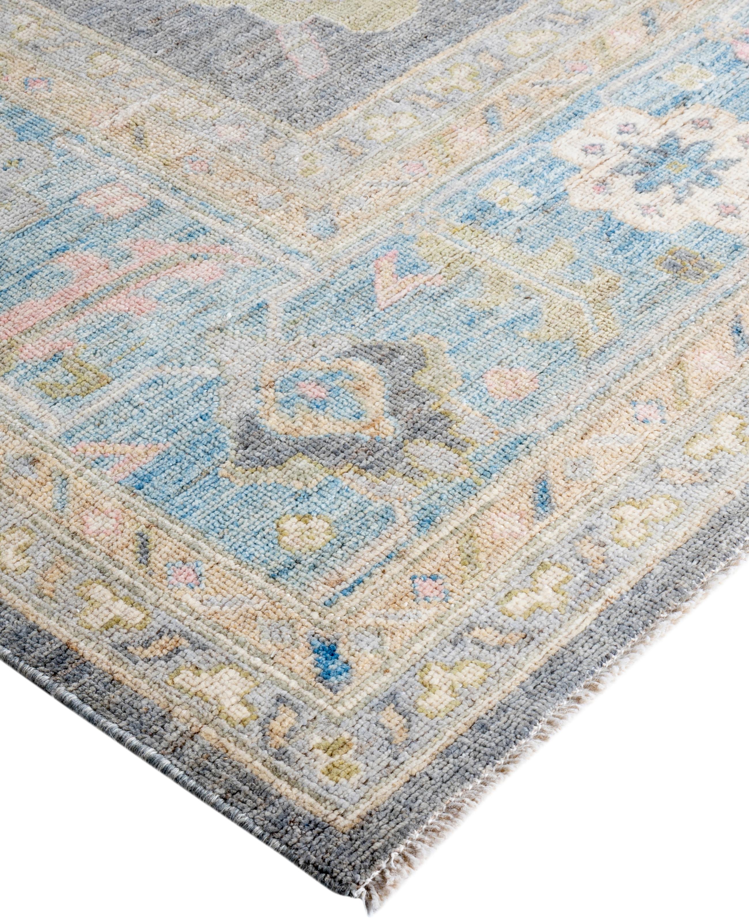 Oushak rugs are known for their soft, muted color palettes and large-scale, flowing designs. They often feature soft tones like beige, cream, gold, and light blue, with motifs that include palmettes, vines, and geometric shapes. These rugs are
