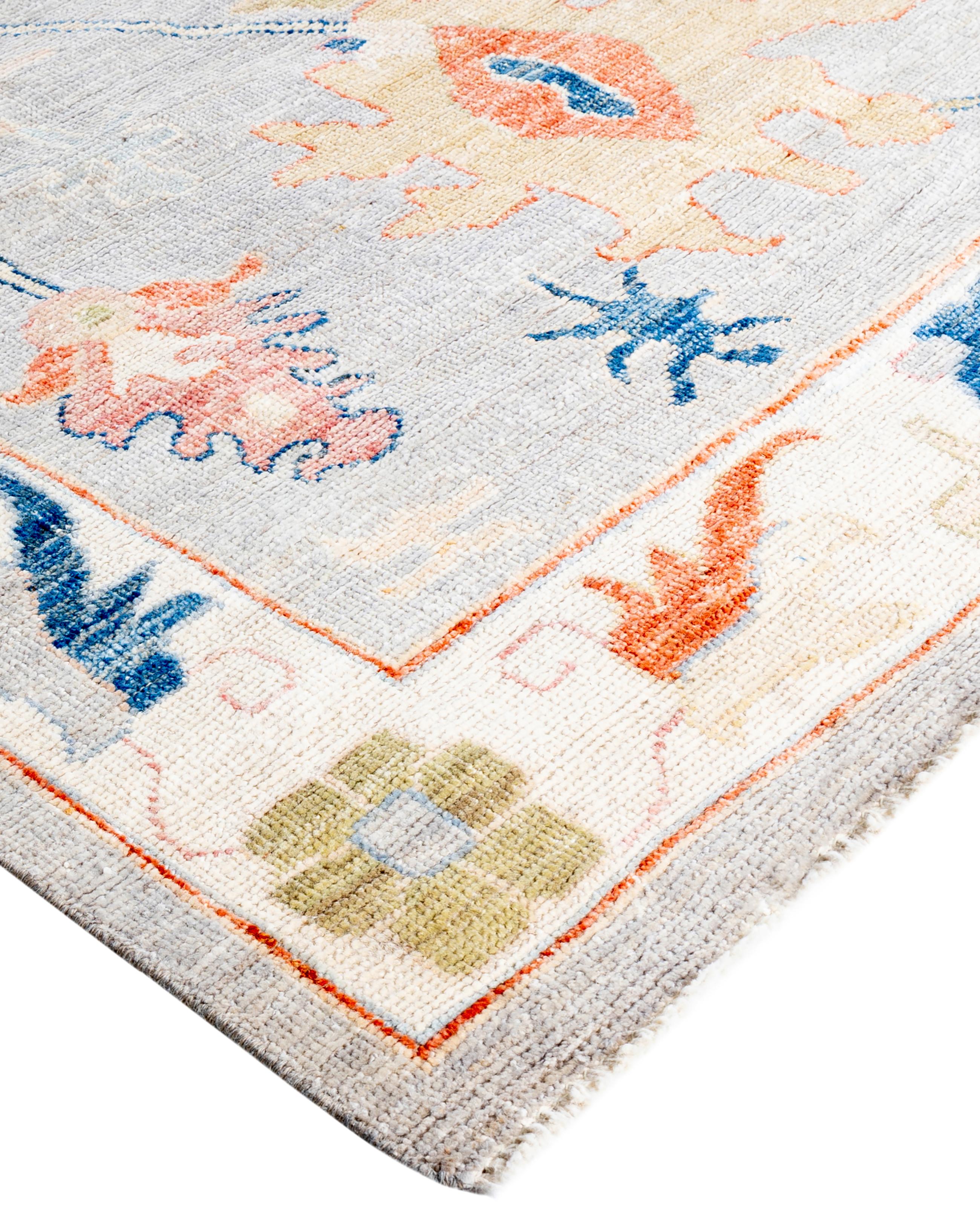 Oushak rugs are known for their soft, muted color palettes and large-scale, flowing designs. They often feature soft tones like beige, cream, gold, and light blue, with motifs that include palmettes, vines, and geometric shapes. These rugs are