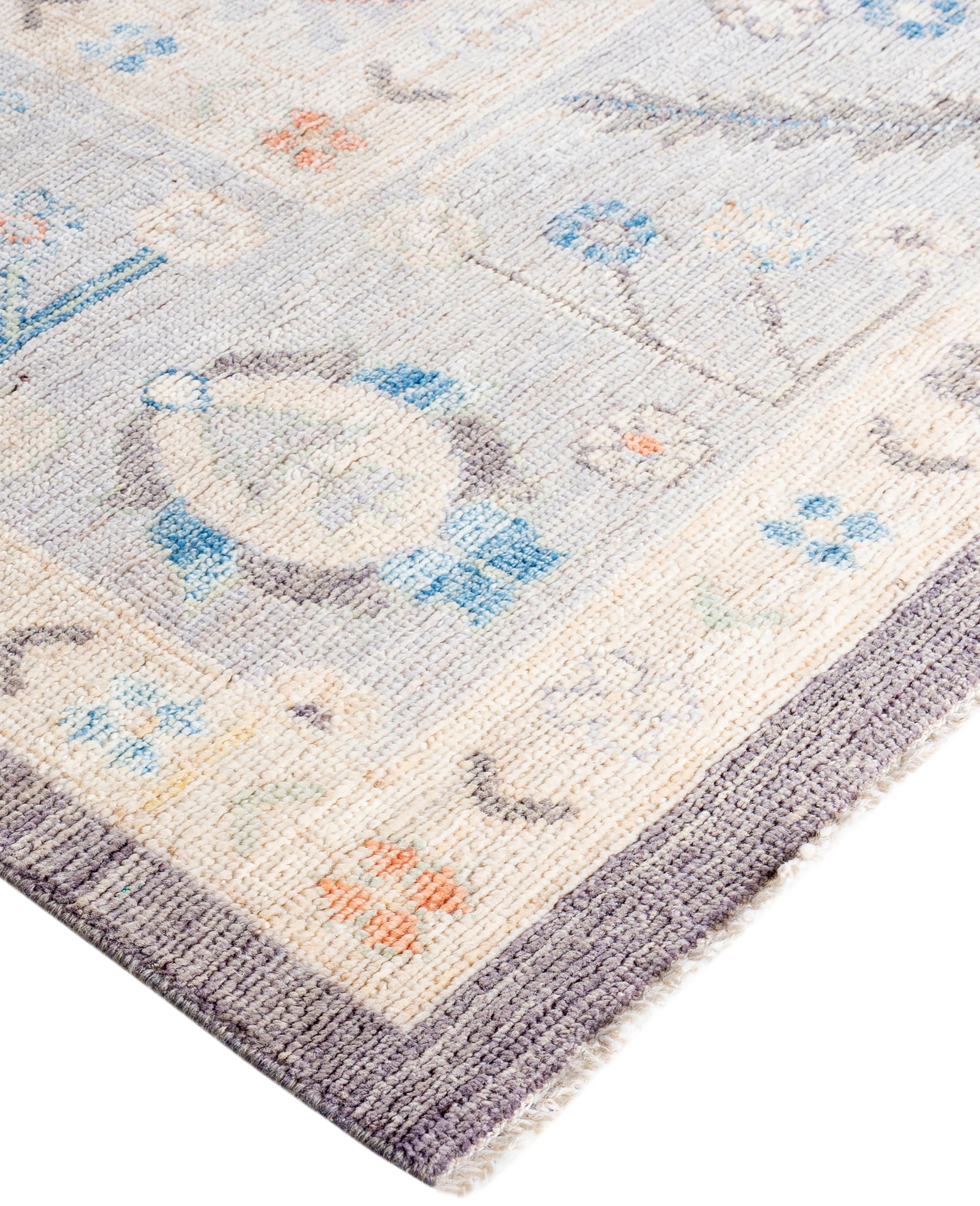 Oushak rugs are known for their soft, muted color palettes and large-scale, flowing designs. They often feature soft tones like beige, cream, gold, and light blue, with motifs that include palmettes, vines, and geometric shapes. These rugs are