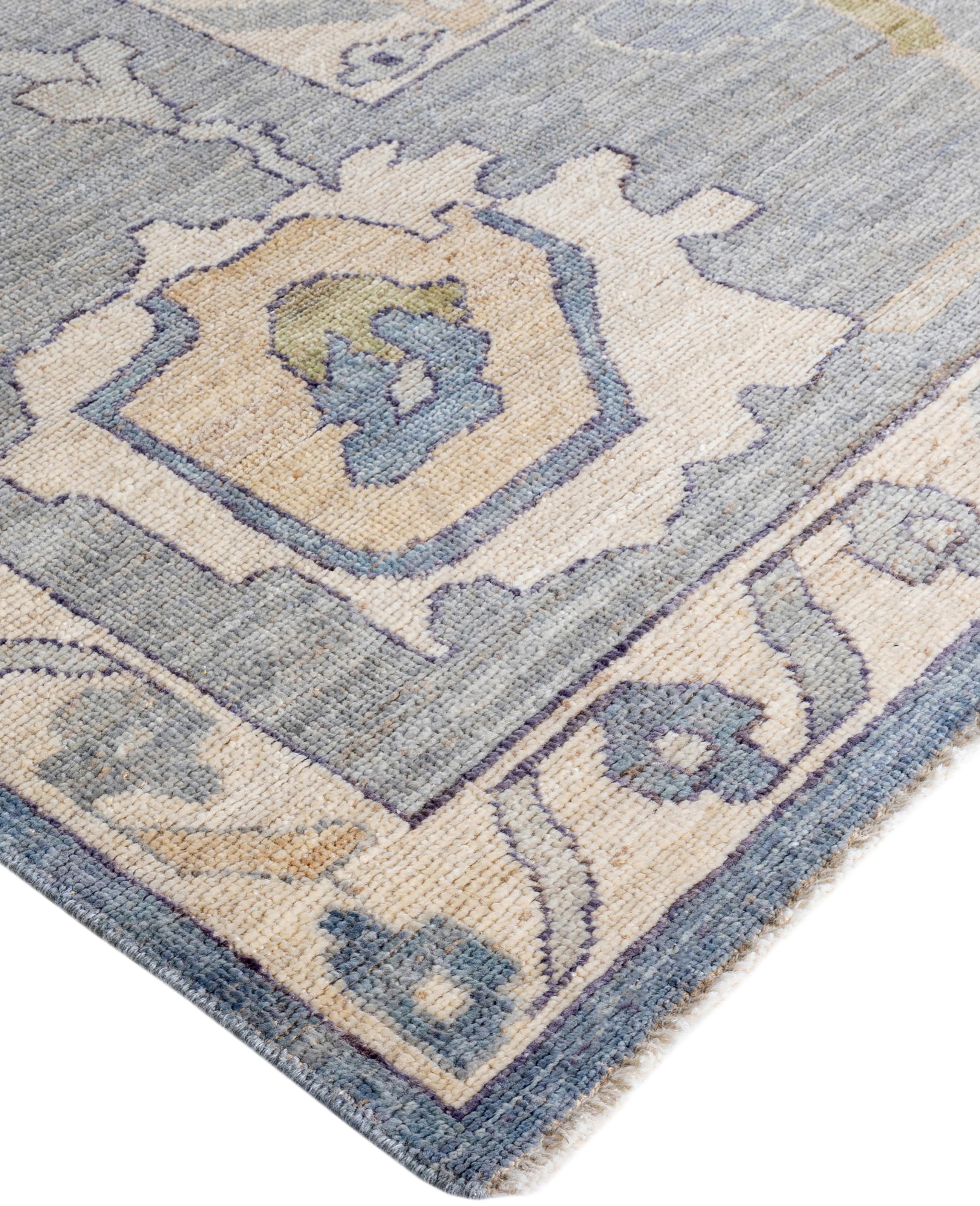 Oushak rugs are known for their soft, muted color palettes and large-scale, flowing designs. They often feature soft tones like beige, cream, gold, and light blue, with motifs that include palmettes, vines, and geometric shapes. These rugs are