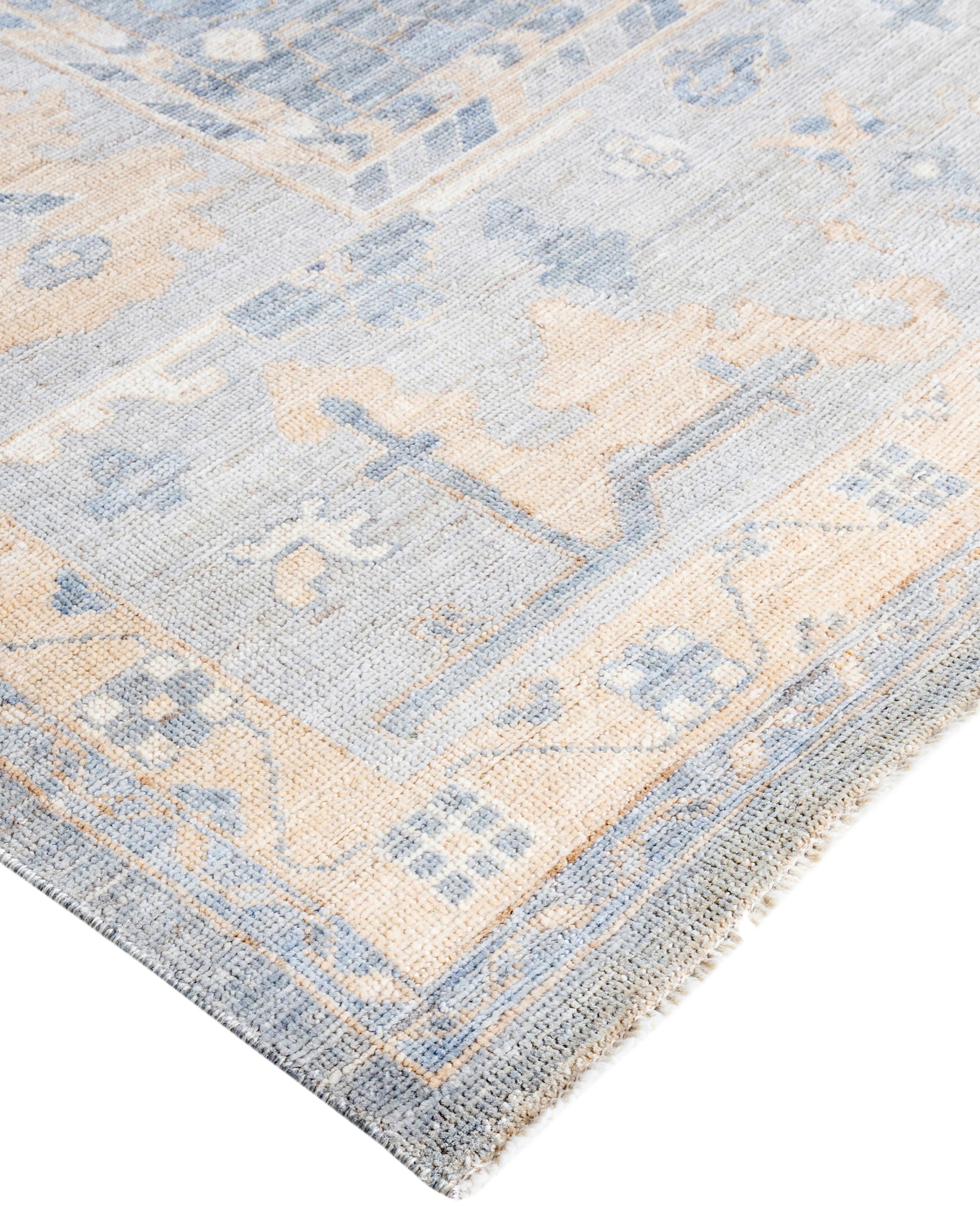 Oushak rugs are known for their soft, muted color palettes and large-scale, flowing designs. They often feature soft tones like beige, cream, gold, and light blue, with motifs that include palmettes, vines, and geometric shapes. These rugs are