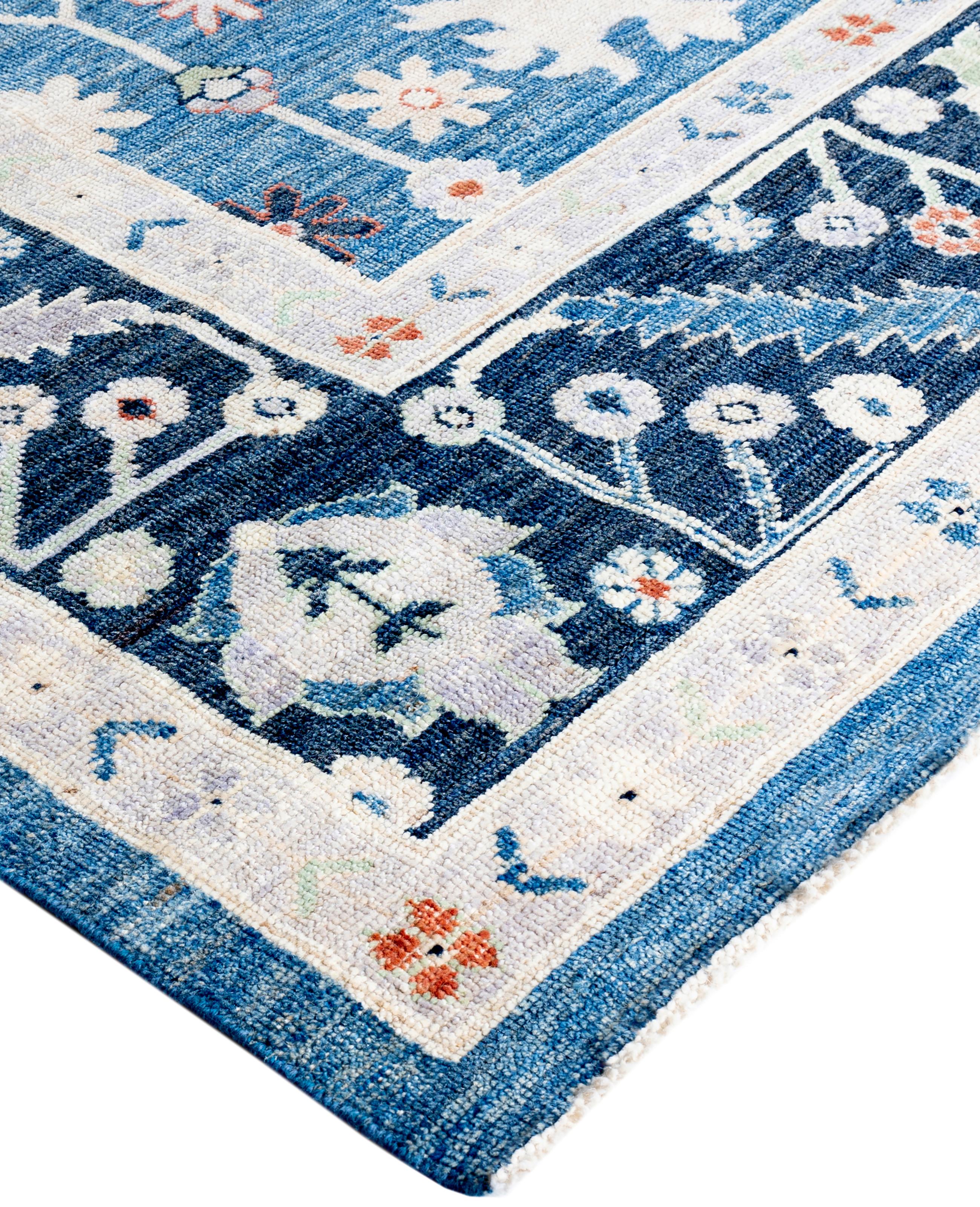 Oushak rugs are known for their soft, muted color palettes and large-scale, flowing designs. They often feature soft tones like beige, cream, gold, and light blue, with motifs that include palmettes, vines, and geometric shapes. These rugs are