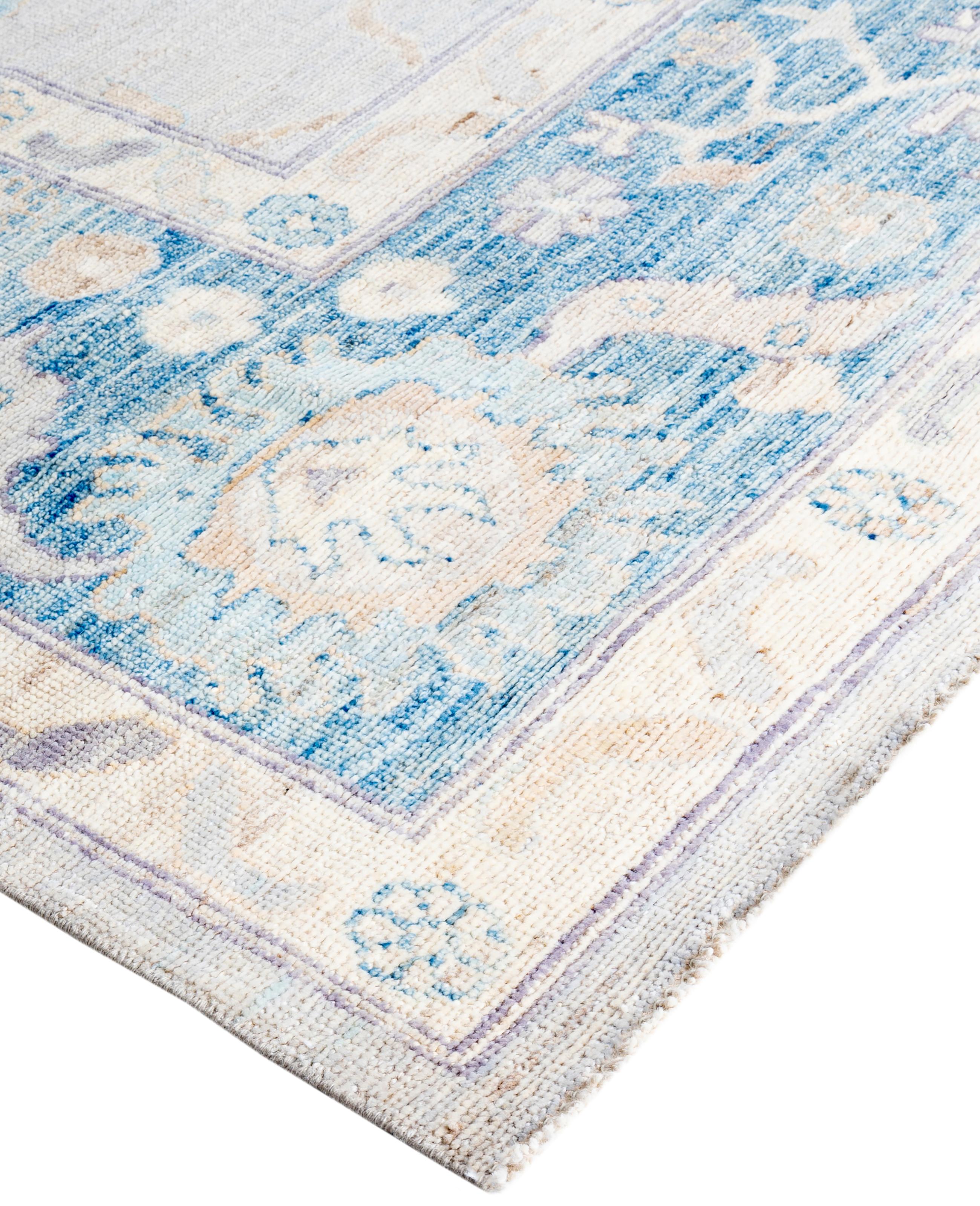 Oushak rugs are known for their soft, muted color palettes and large-scale, flowing designs. They often feature soft tones like beige, cream, gold, and light blue, with motifs that include palmettes, vines, and geometric shapes. These rugs are