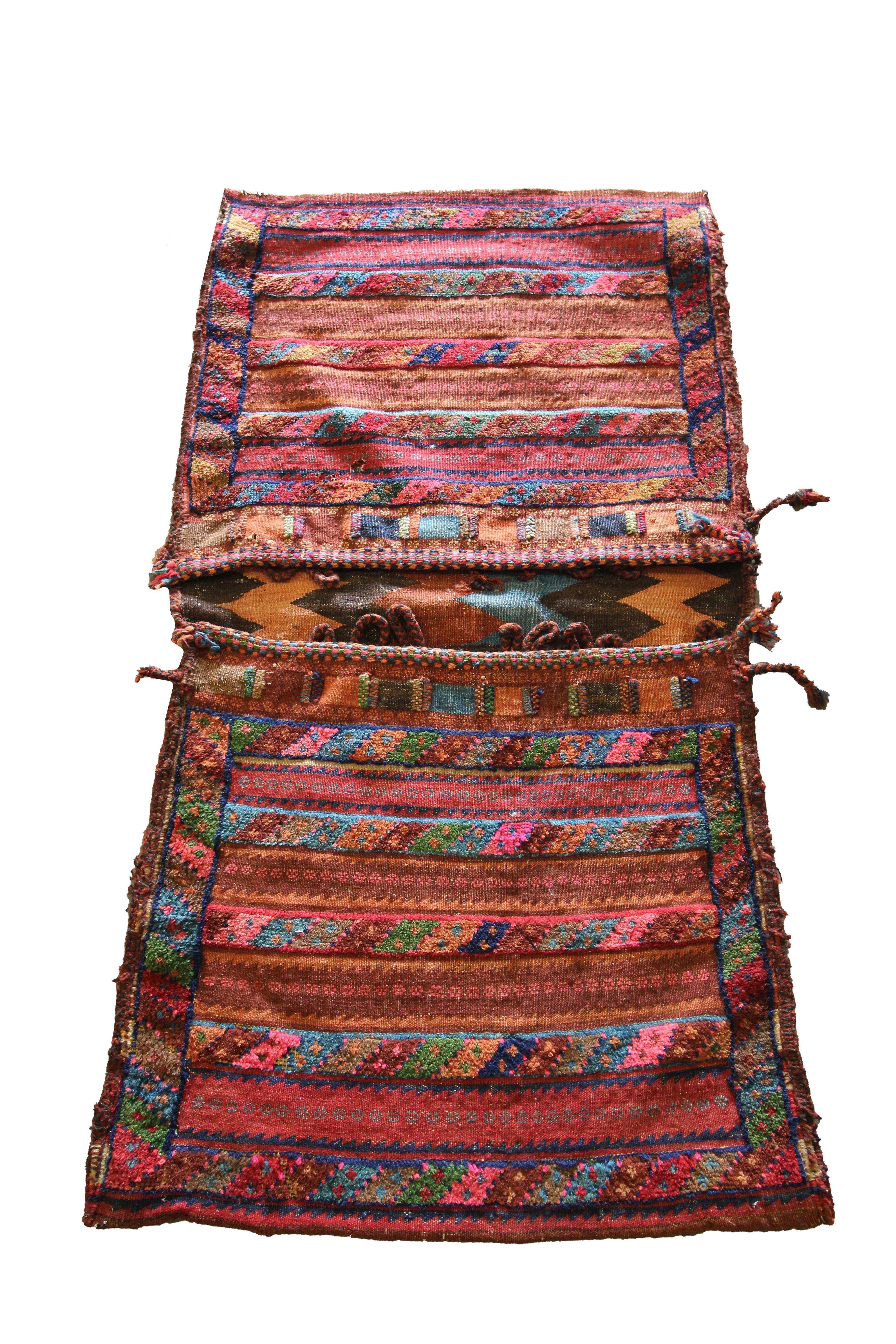 This handwoven textile is an extremely rare Khorjin/ saddle bag woven in the early 20th century. Saddlebags were traditionally used as storage which nomadic travellers used upon horseback. The design features a traditional geometric stripe pattern