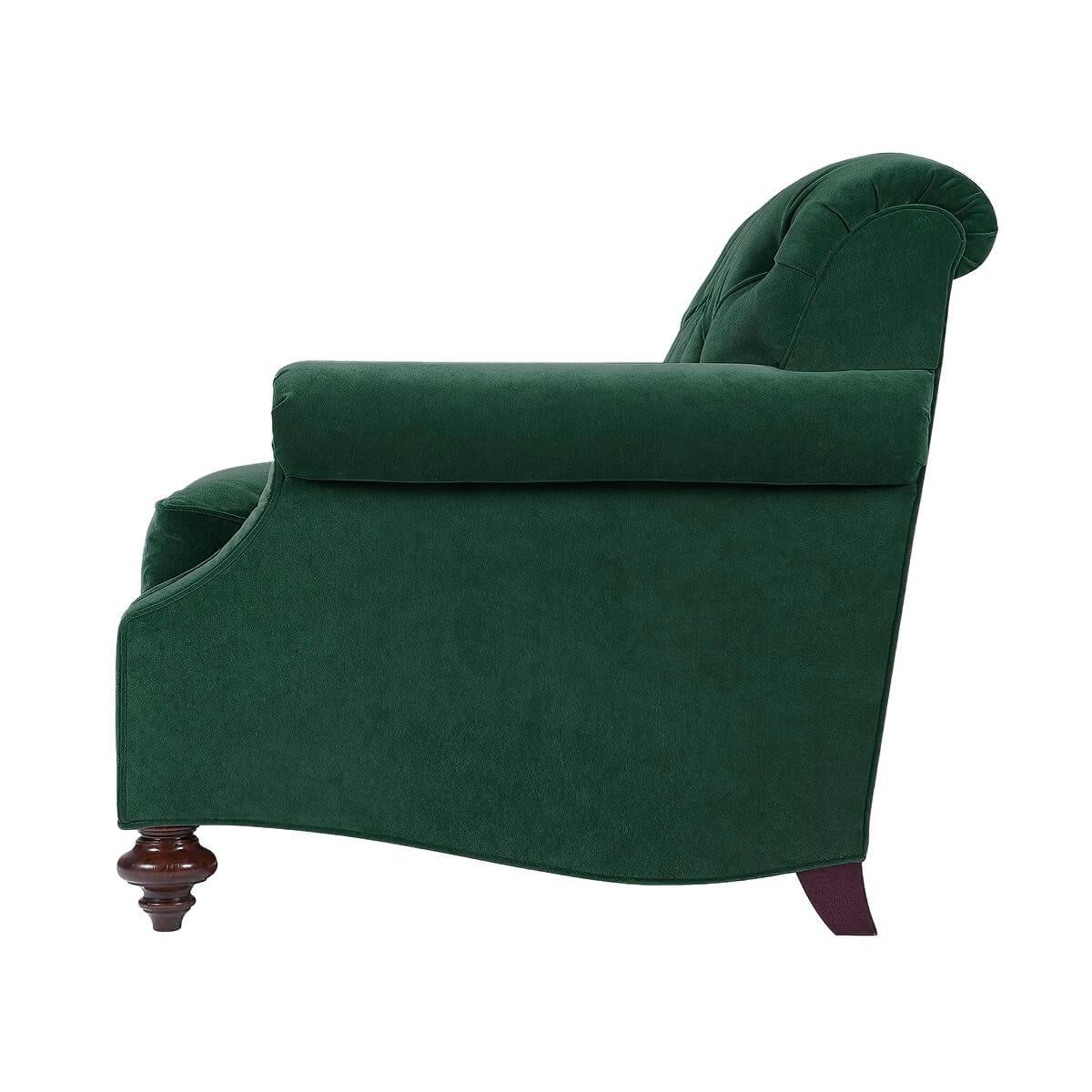 An upholstered chair, the tufted back and loose cushion seat between traditional roll arms, on mahogany stained turned legs. The solid maple frame with 8-way hand-tied upholstery.

Dimensions: 37