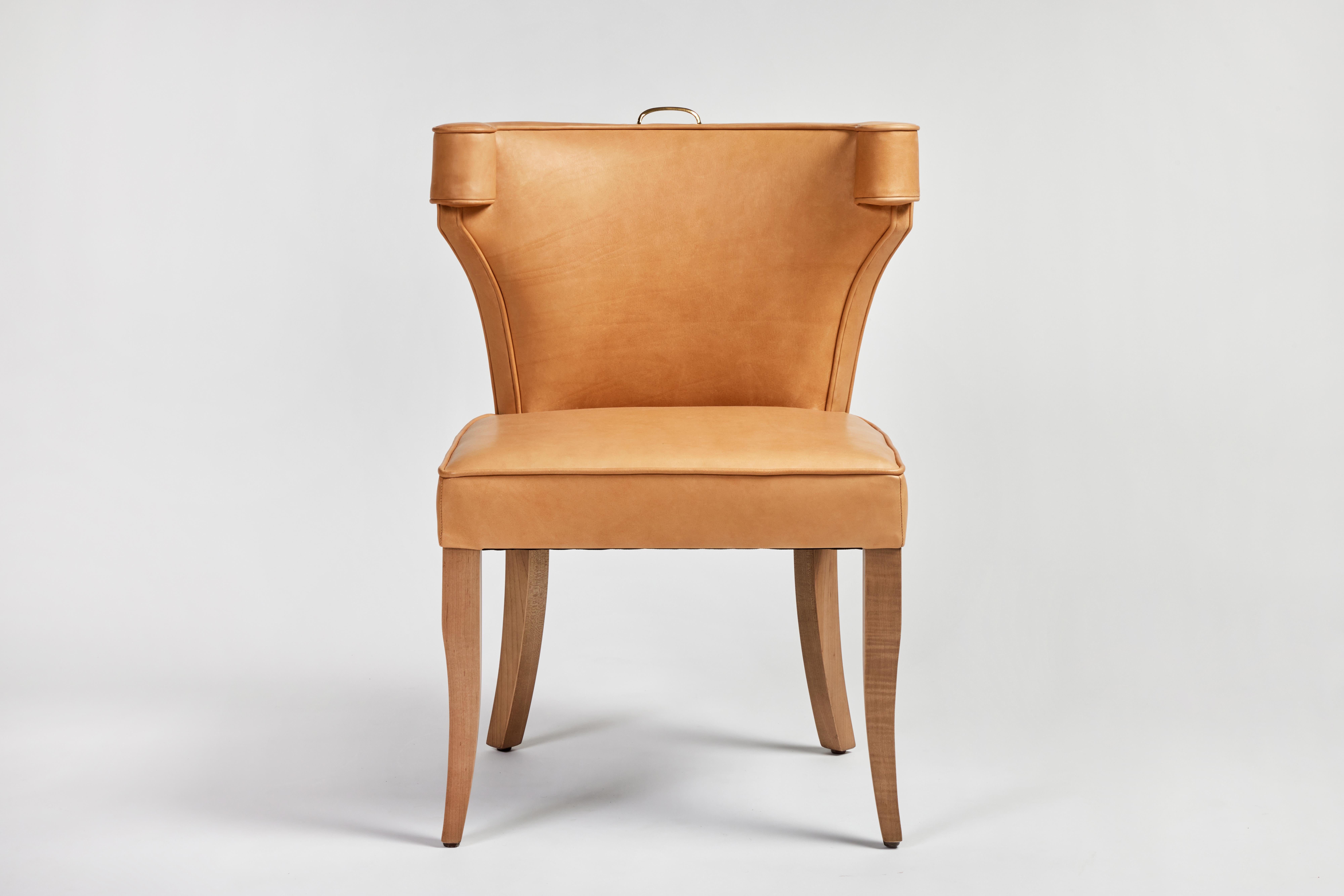 The Martin and Brockett Hale chair has a fully upholstered curved back, without nailhead trim. Oak saber legs with an unlacquered brass handle detail. 

C.O.M. only -3 yards 
Other wood finishes available.

Lead time: 8-10 weeks.