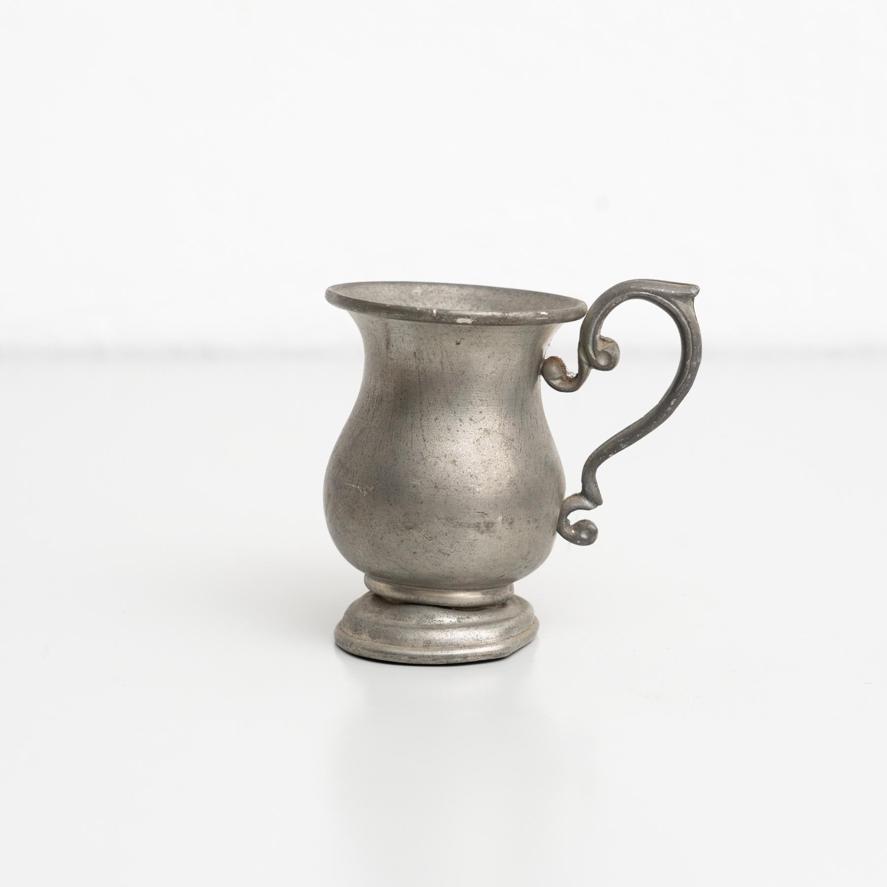 Traditional vintage metal jug.    By unknown manufacturer, made in Spain circa 1970.    In original condition, with minor wear consistent with age and use, preserving a beautiful patina.    Materials:  Metal.   