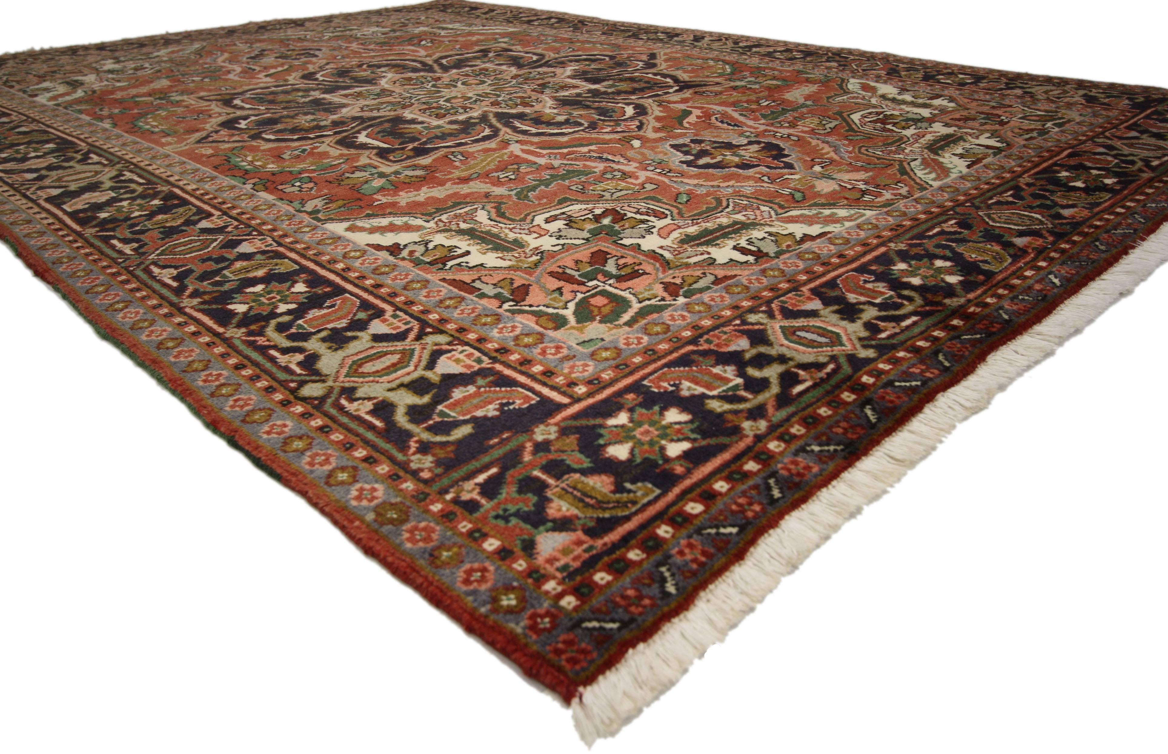 76008, Traditional Vintage Persian Heriz Rug with Jacobean Style. This hand knotted wool vintage Persian Heriz rug features a large concentric octofoil medallion with palmette pendants floating in the center of an abrashed red field. Closed