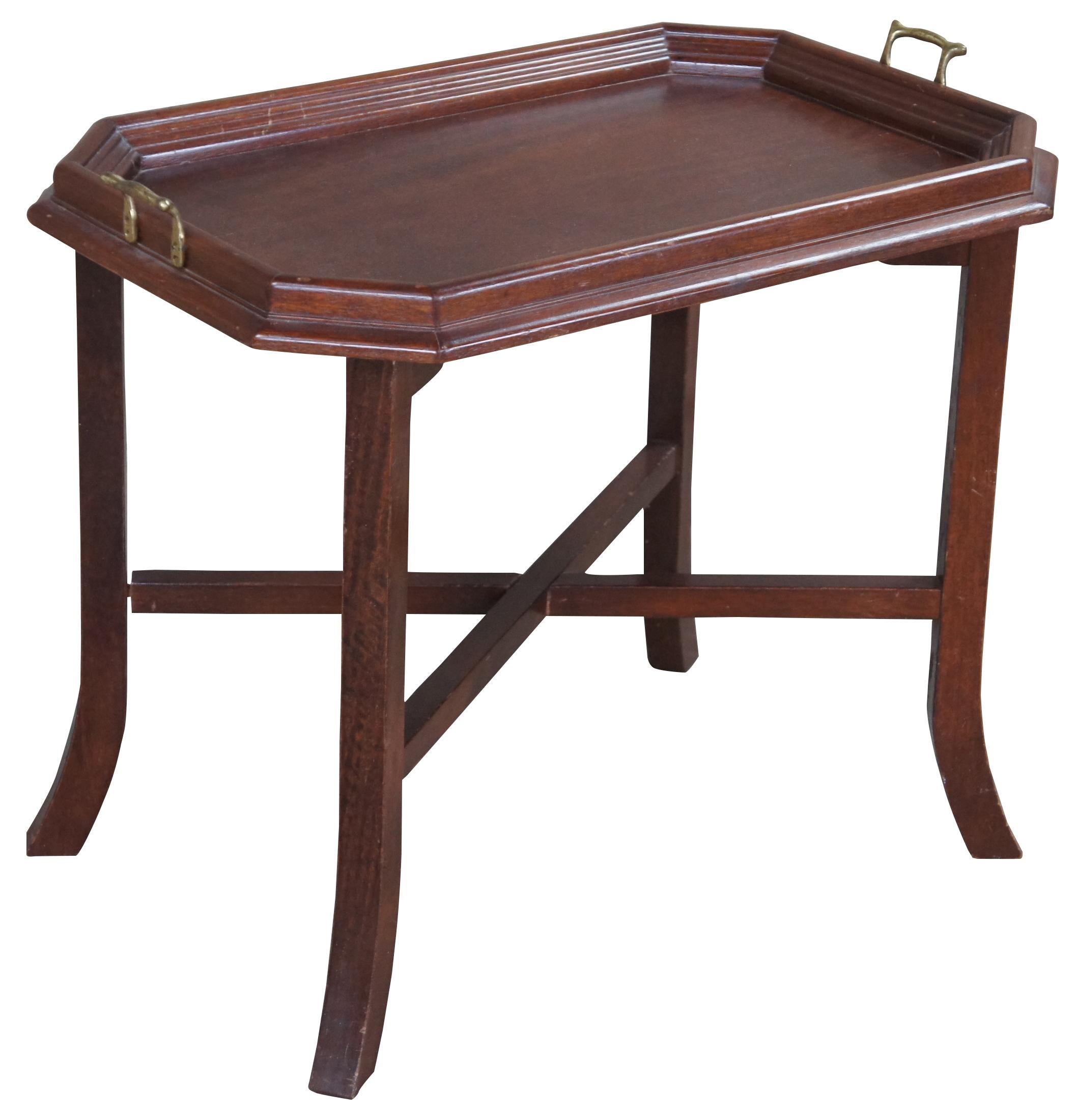 Vintage pine tray table. Features a folding base connected by X stretcher and rectangular octogon shaped top with brass handles.
  