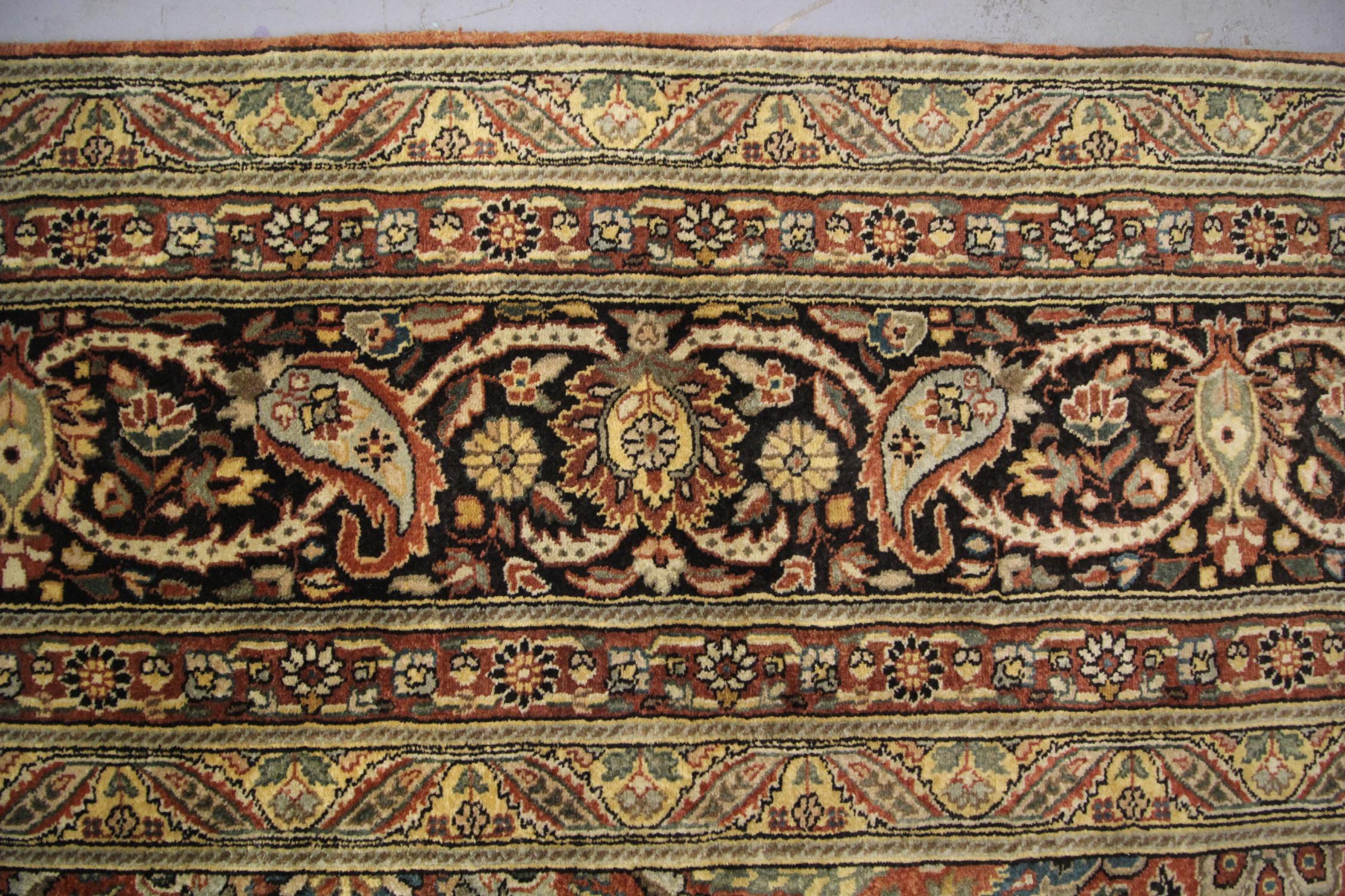 This handmade wool area rug has been woven with a remarkable floral design in accents of brown, beige and cream on a luxurious rust background. This has then been framed by a layered border with decorative paisley patterns. Both the colour and