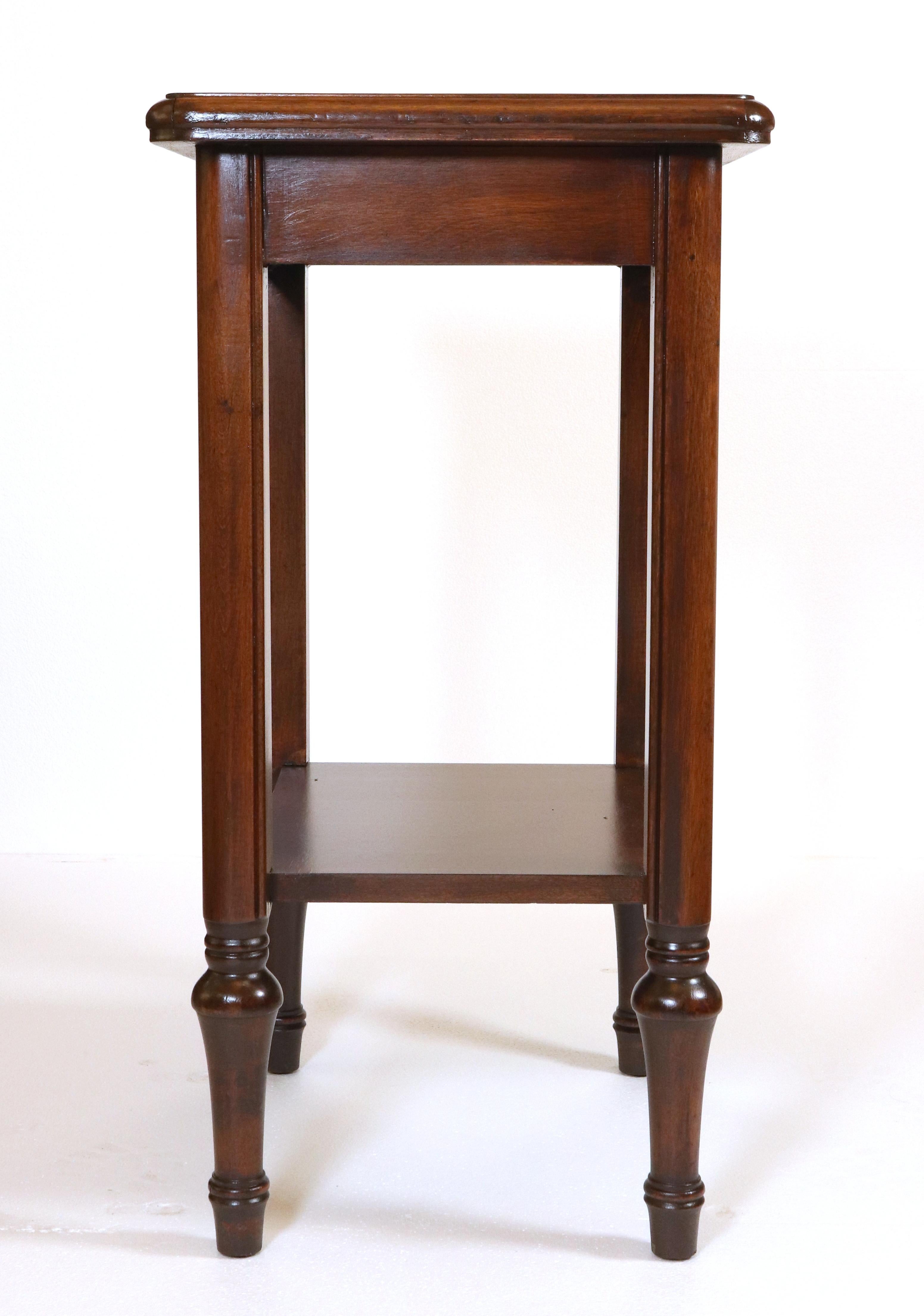 Traditional style end table made of dark stained wood and features a bottom shelf. Good condition with some scratches and discoloration on top. One available. Please note, this item is located in our NYC location.