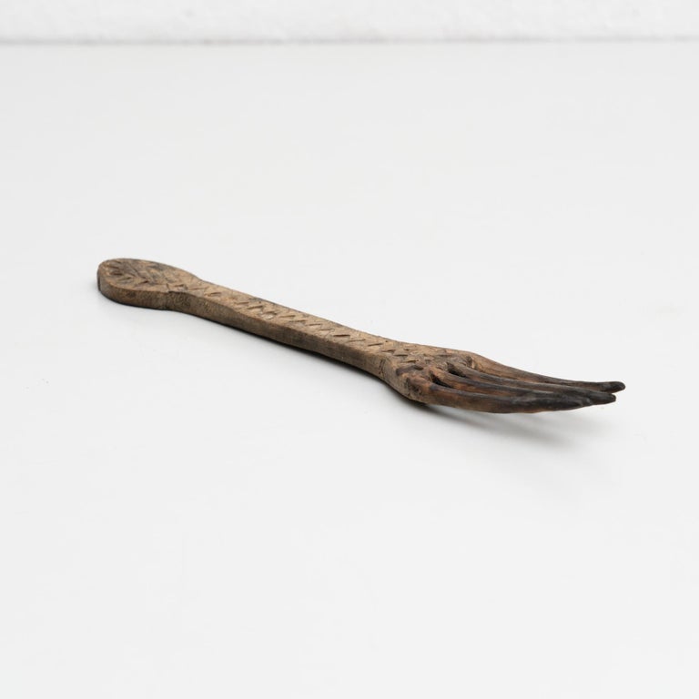 Traditional pastoral primitive wooden carved fork.

Handmade in Spain, circa 1900.

In original condition, with minor wear consistent with age and use, preserving a beautiful patina.

Materials:
Wood.