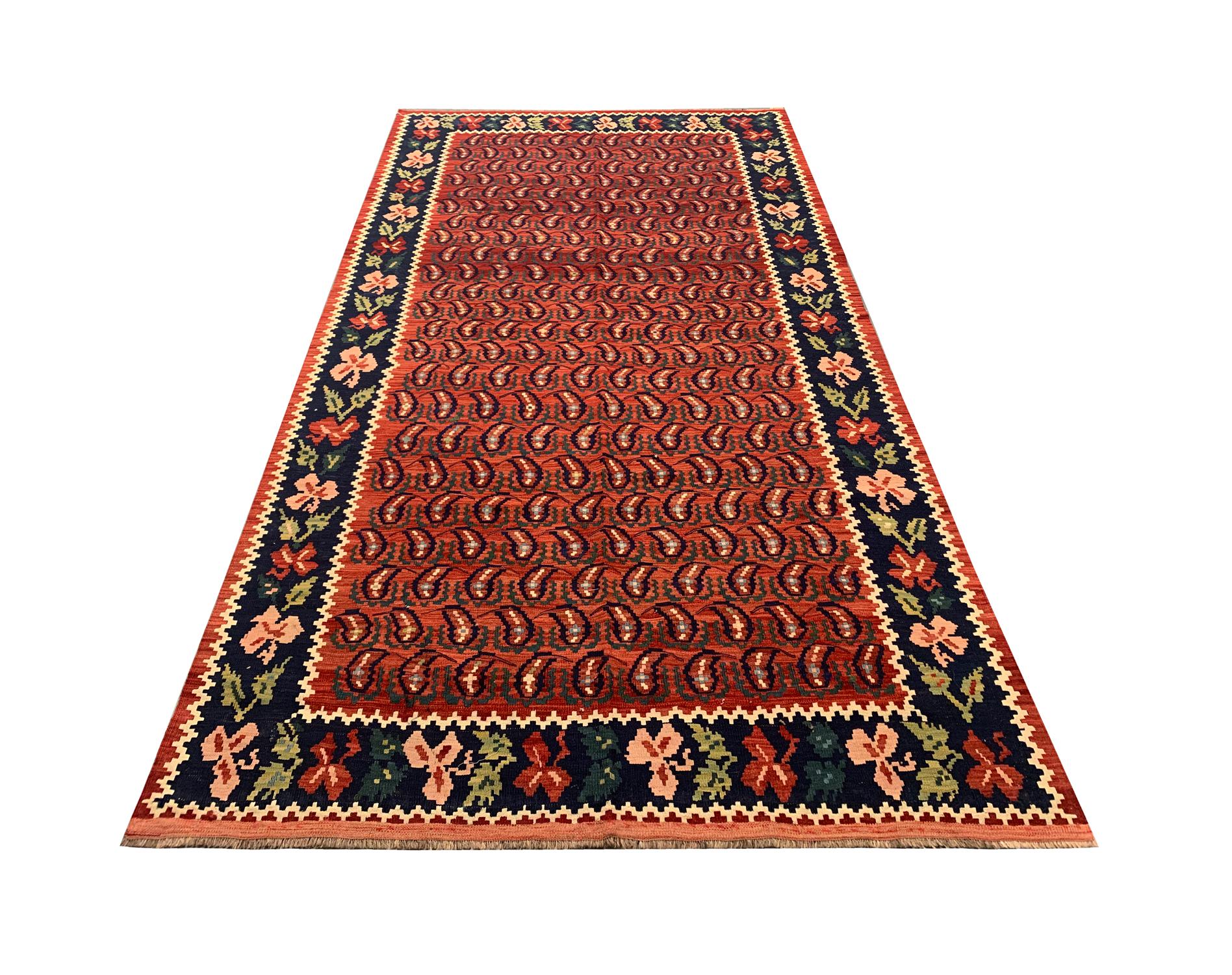 This beautiful Caucasian Karabagh Kilim rug has been woven by hand with fine hand-spun wool. The rich colours in this piece come from natural dyeing techniques which have been used for generations. An all-over repeat pattern covers the red field in