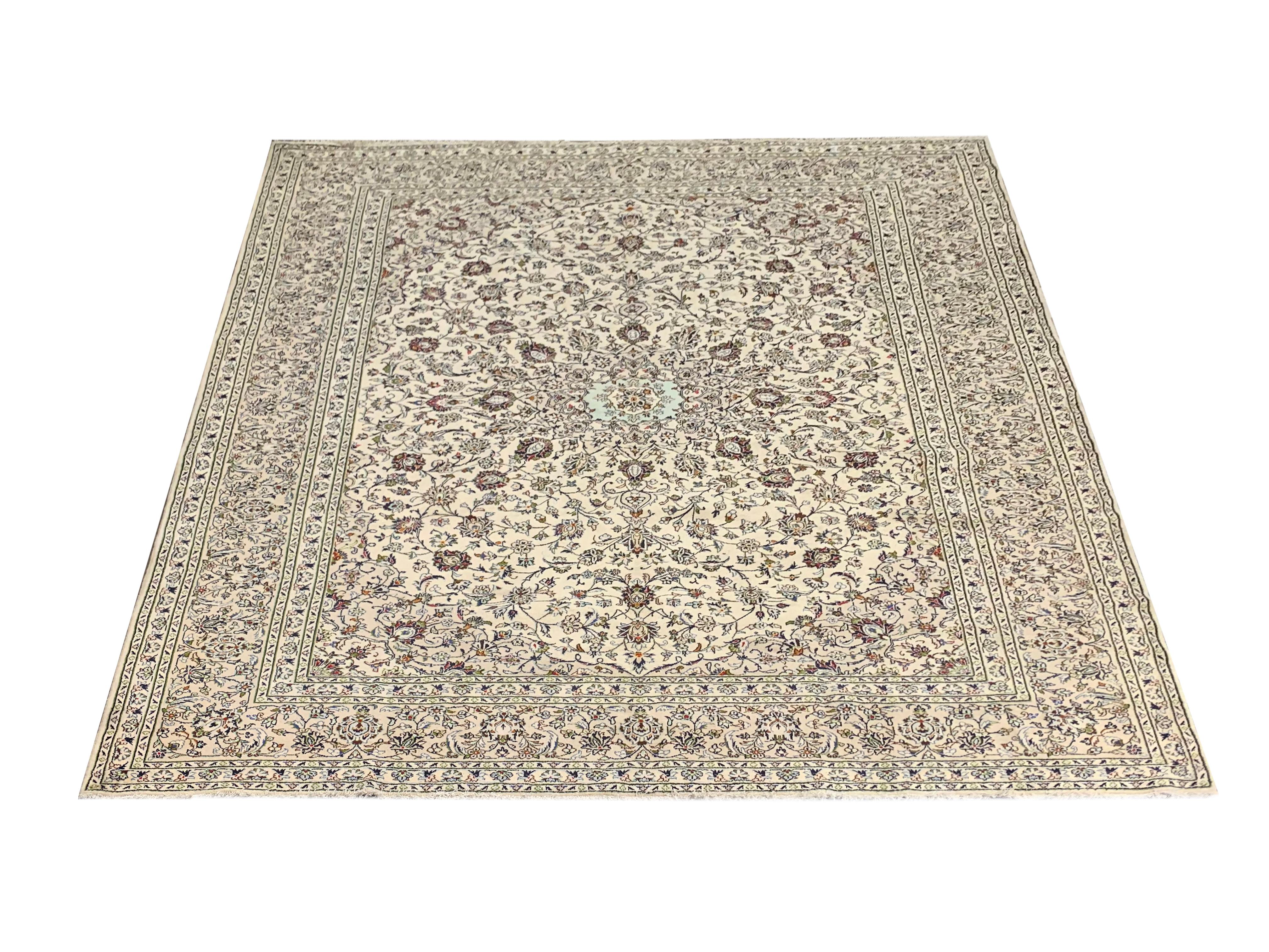 A bold, symmetrical pattern adorns this fine wool area rug, woven with a sophisticated yet simple colour palette of cream, beige, brown and light blue. Featuring an elegant central medallion that has been enclosed by a highly-decorative floral