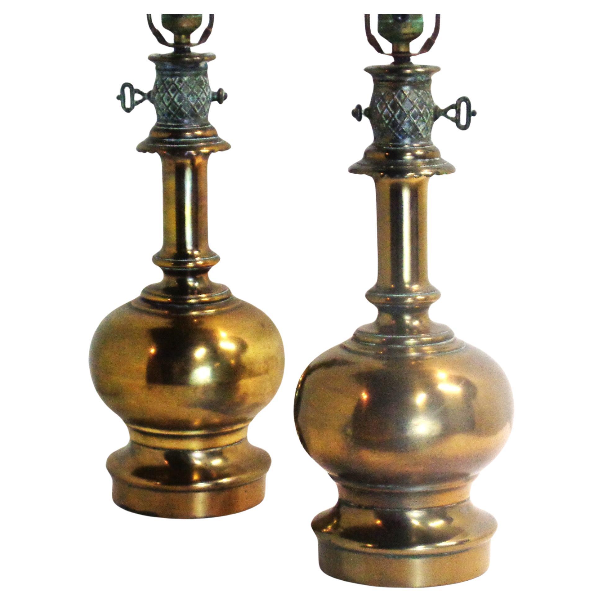 Pair of traditional English Regency style faux kerosene brass table lamps. Nicely aged patinated verdigris surface to nicely detailed decorative metal top posts with key. Great looking original big brass finials. Circa 1940's. Measurements - 29