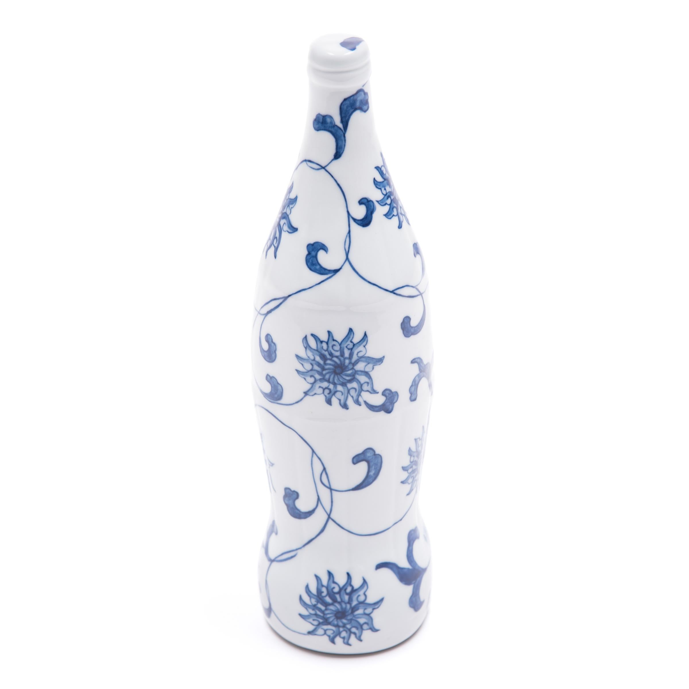 Created by artist Taikkun Li exclusively for Pagoda red, this limited edition hand-painted cola bottle is one of a series drawing on the rich tradition of Chinese blue-and-white ceramics. Fired at the historic Chinese imperial kilns of Jingdezhen,