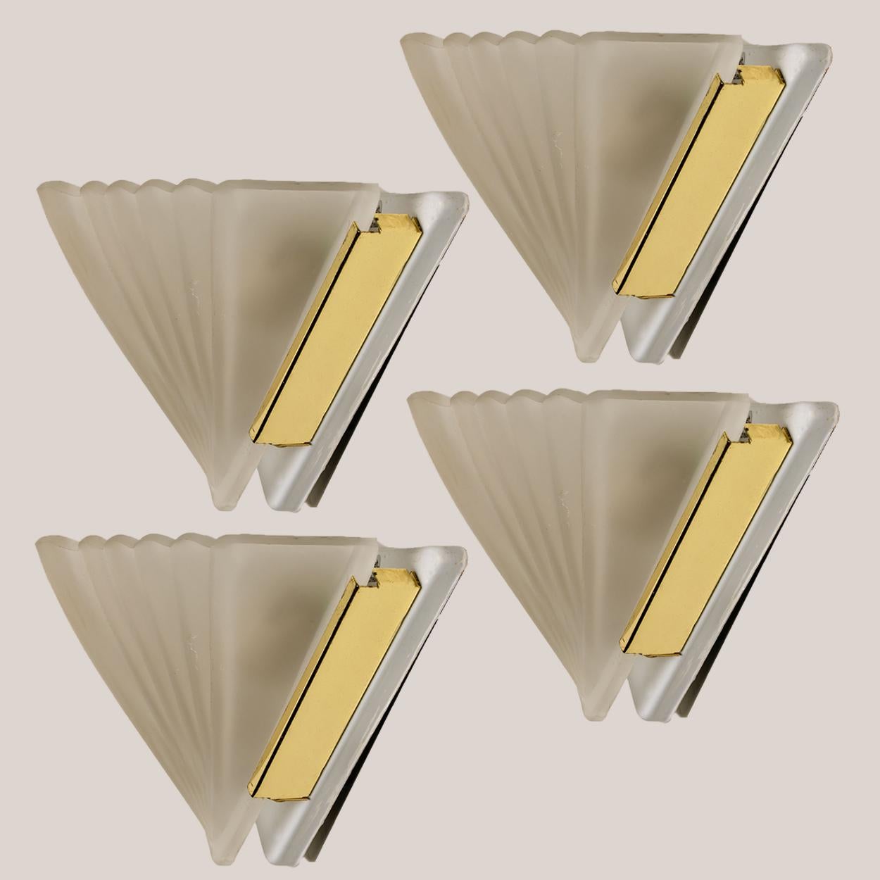 Triangle shaped wall sconces in Art Deco style. The lights are made of thick white milkglass on a white backplate with brass details.

Minimalistic design executed with a taste for excellence in craftsmanship. Good cleaned in very good vintage