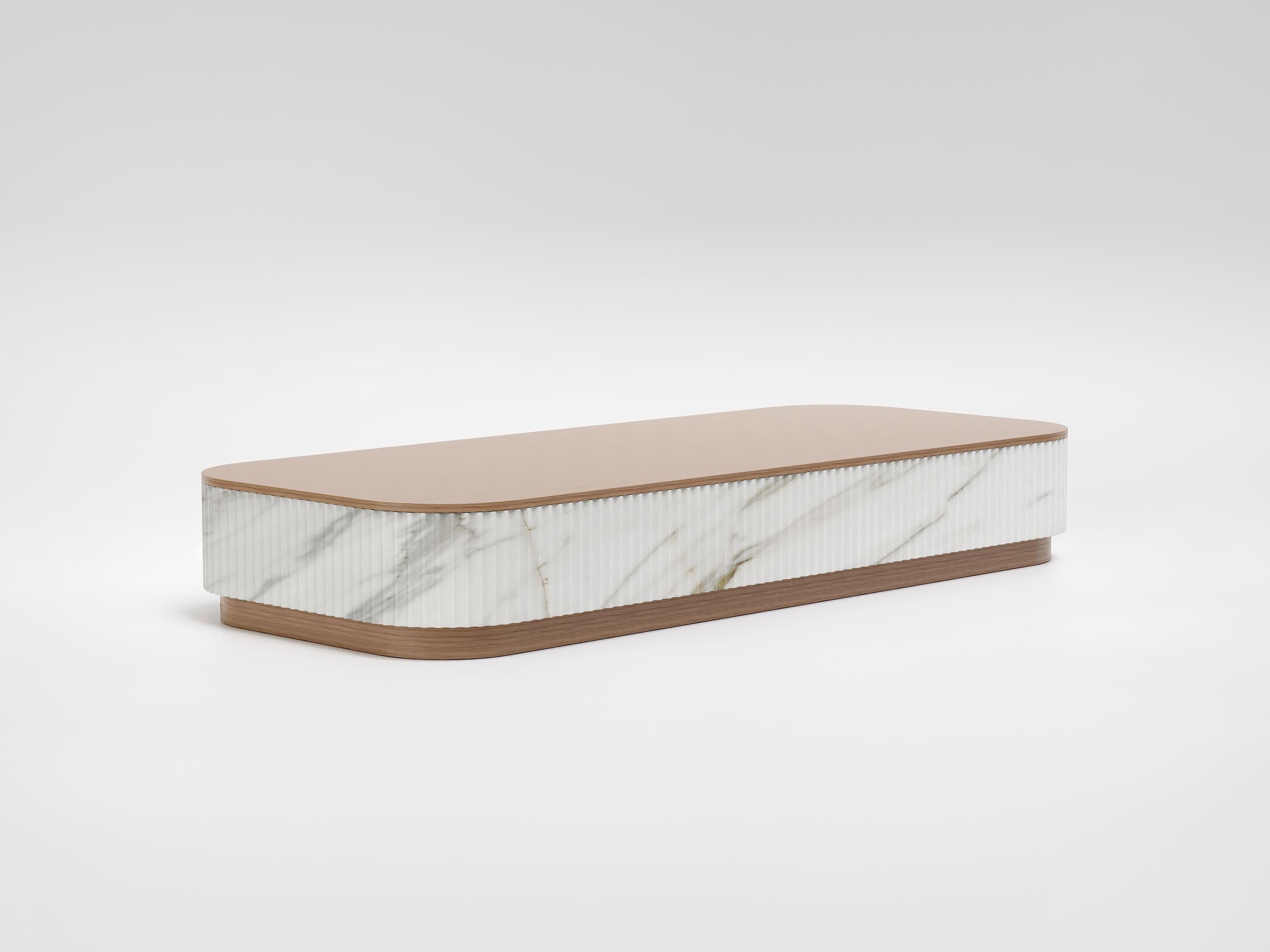 Trama is a large-format coffee table that combines natural materials and craftsmanship in an elegant, contemporary aesthetic.

The base and top are made of brushed white oak wood, while the central element, made of Calacatta marble with continuous