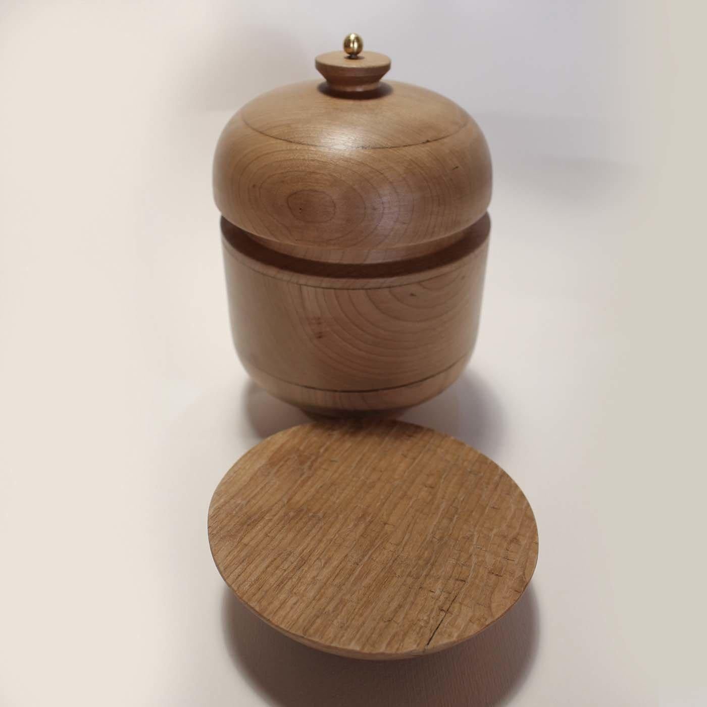 Handcrafted of lathe-turned cherry and finished with a protective water-based, non-toxic finish, this stunning object of decor is composed of three pieces that can be displayed in different combinations. The main piece is shaped like a footed urn