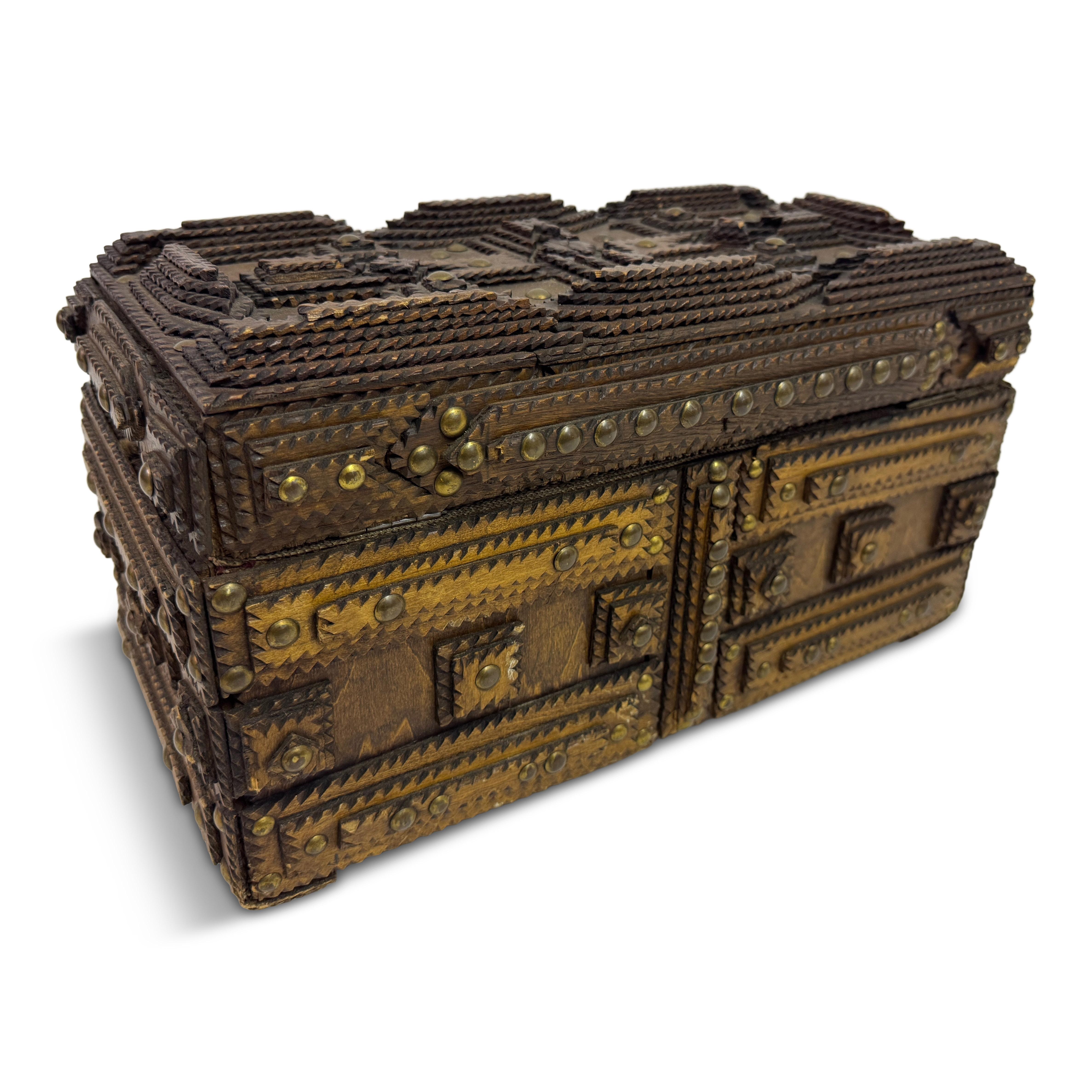 Tramp Art Box or Chest, Early 20th Century


Finely detailed tramp art box, hand-carved from layers of chip-carved wood and embellished with brass tacks. The intricate geometric construction — built up from notched and layered wooden elements —