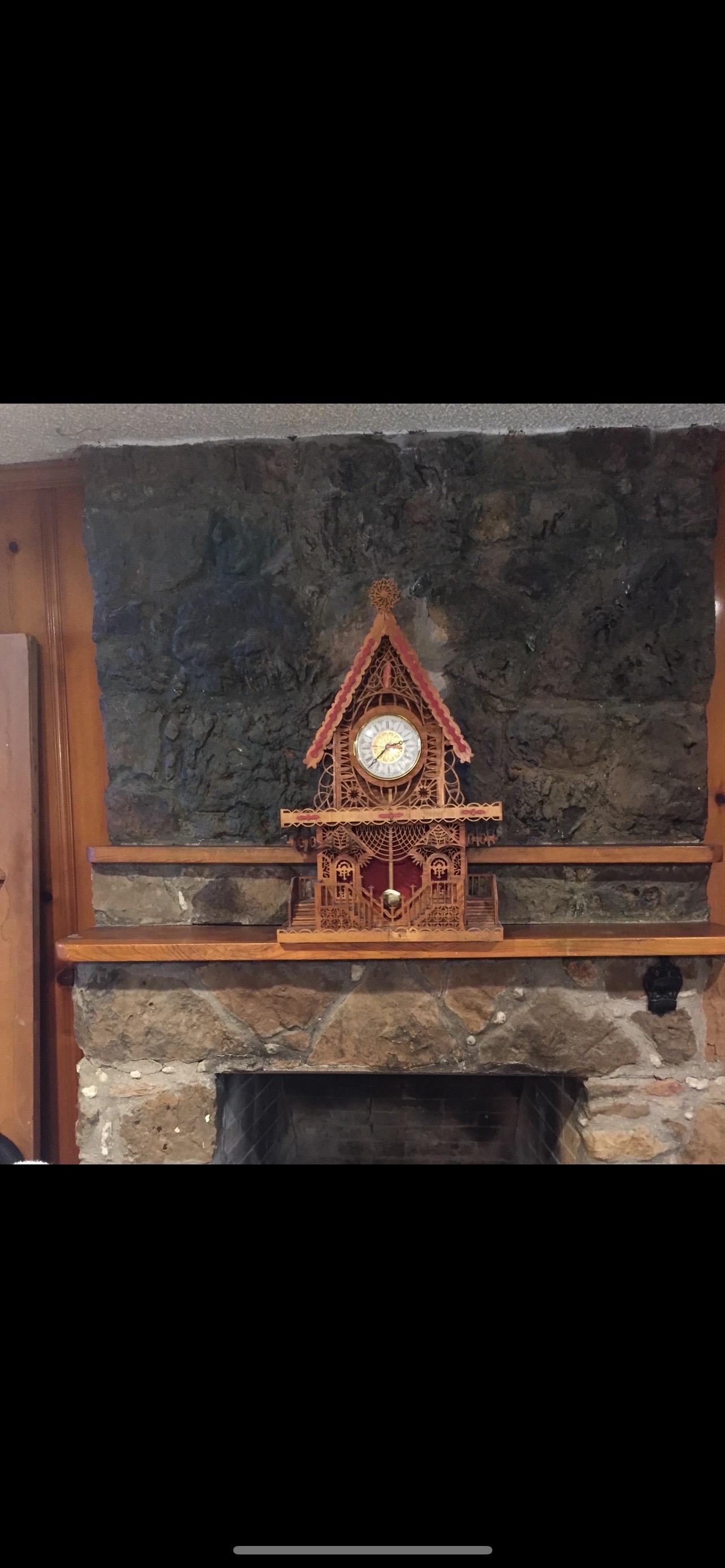Tramp Art Clock.
Offered is a rare Tramp Art clock with fantastic detailing. This outstanding folk art clock
features multiple staircases, some with canopies and many interesting levels to explore. The handmade clock is in great condition with the