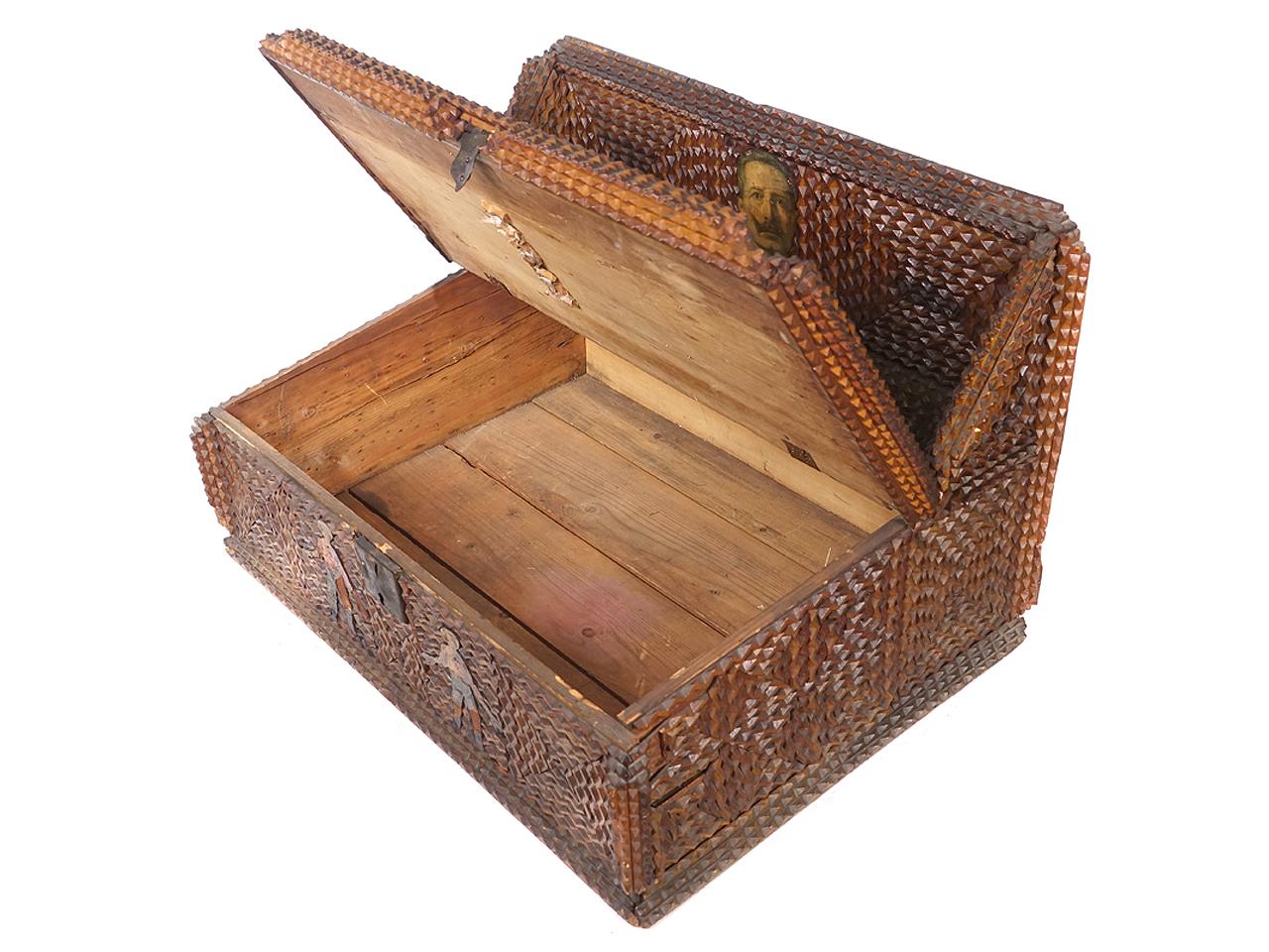 This is a nicely tightly detailed tramp art box with lift up door. Also of interest is are the decoupage highlights. A few small decorative pieces are missing.
 