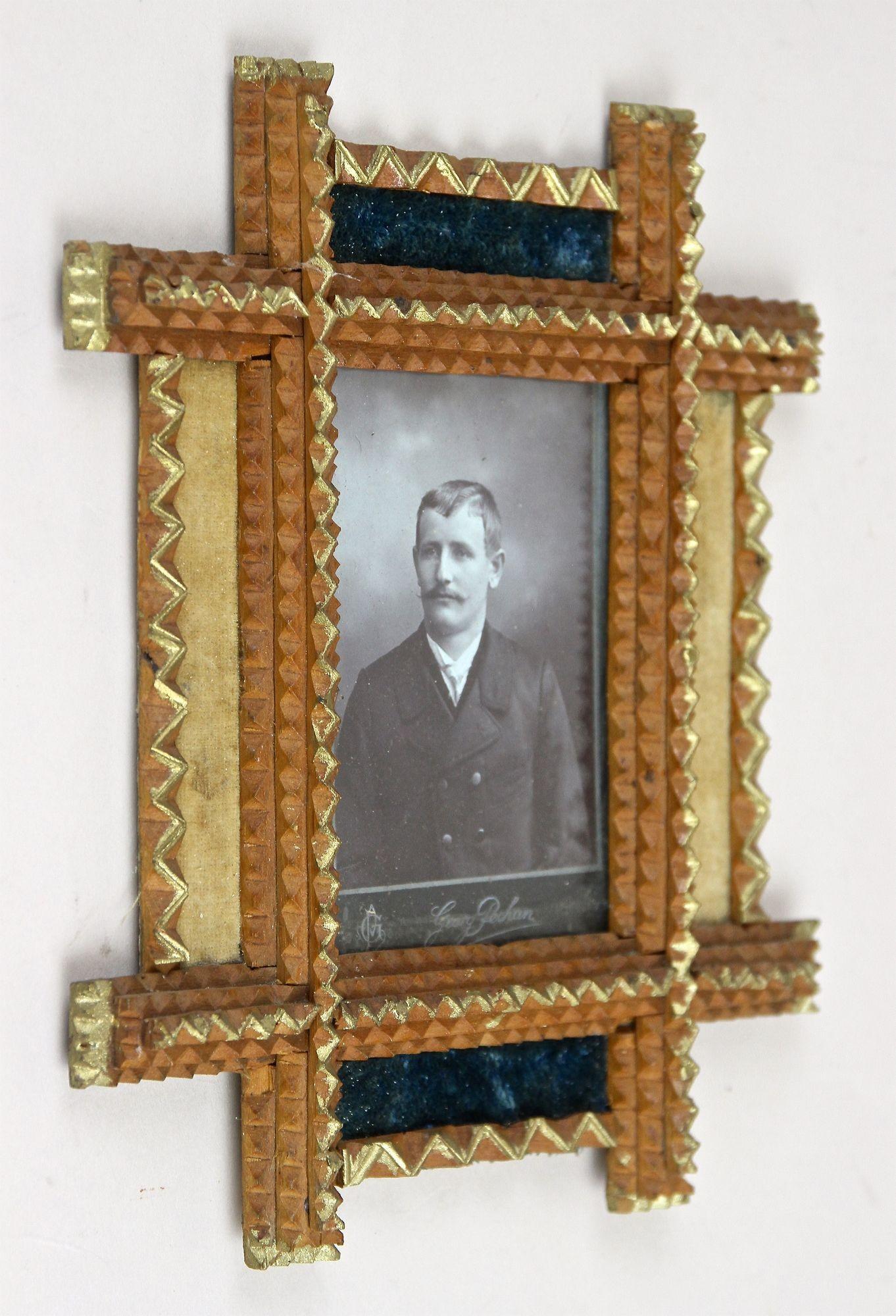Extrordinary Tramp Art photo frame from the period in Austria around 1890. Elaborately hand carved out of bass this antique rustic photo frame impresses with an unusual doubled frame: the beautiful inner section shows the so-called 