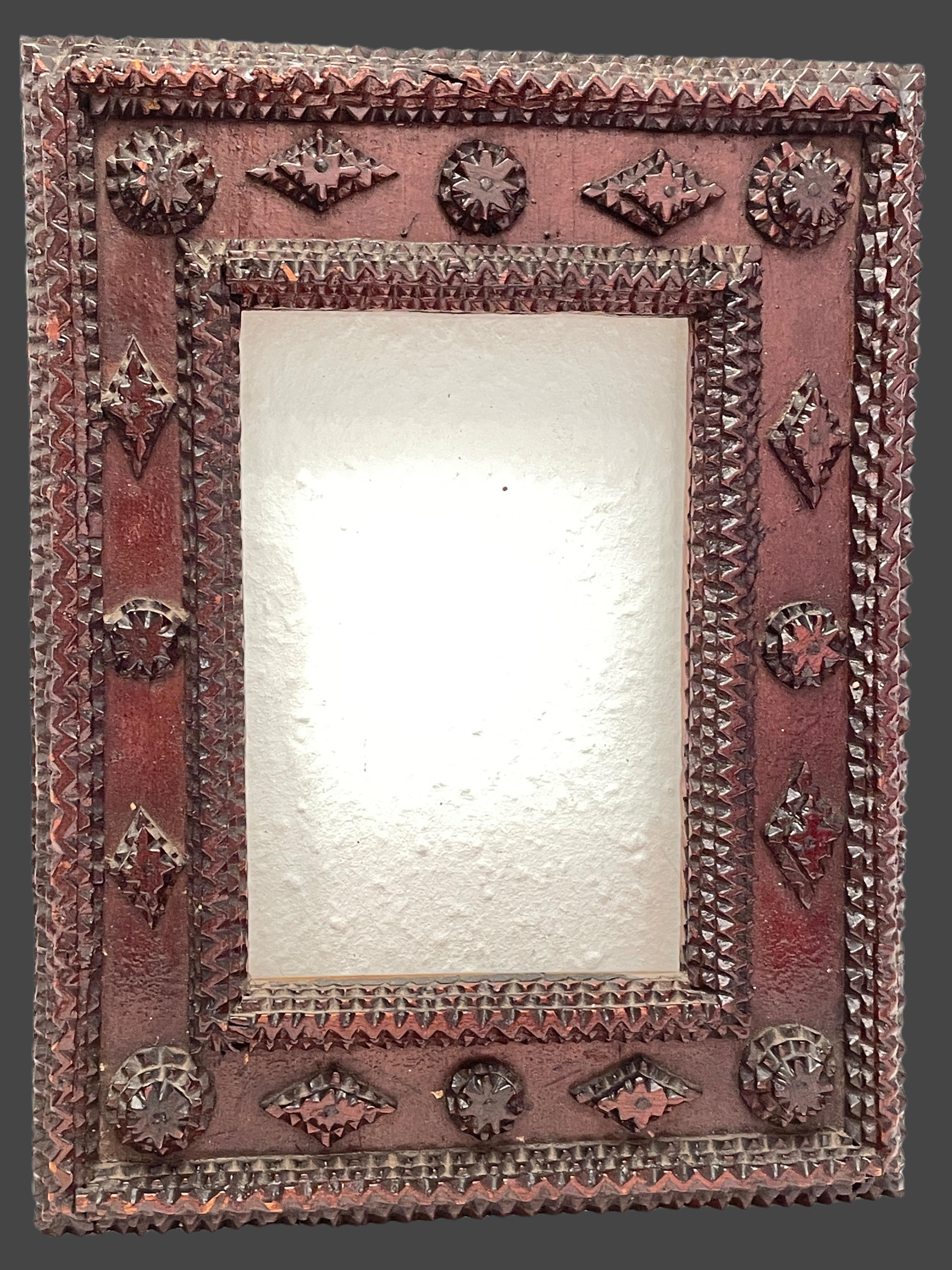 A petite German late 19th century Tramp Folk Art frame. This petite Tramp Art frame, circa 1880 comes from Germany and features a finely carved frame surrounding an original glass.
Viewable picture size is approx. 7