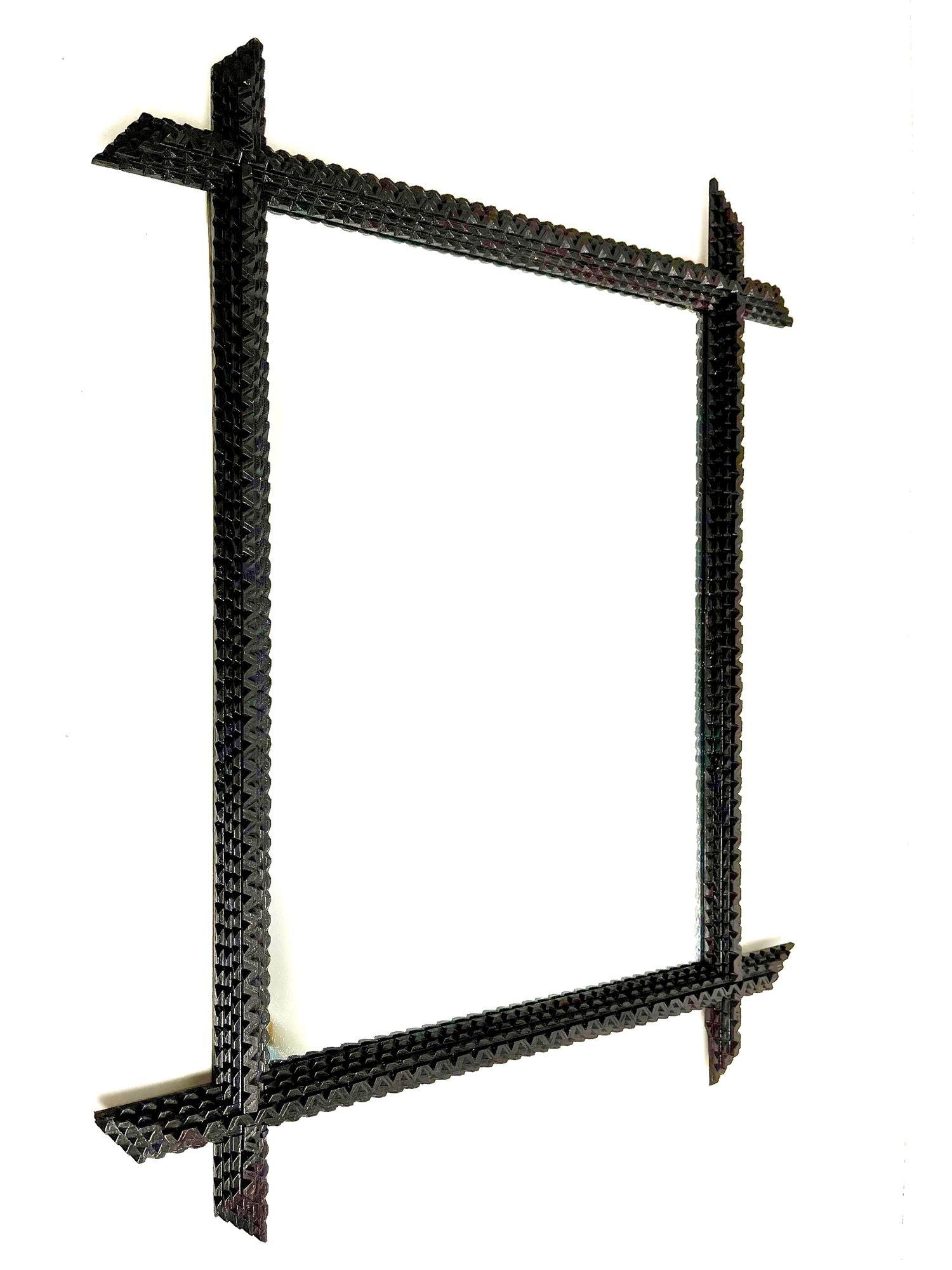Beautiful rustic Tramp Art Mirror from the late 19th century in Austria, elaborately handcarved around 1890. This unique wall mirror impresses with its slim, chip carved designed frame, the famous 