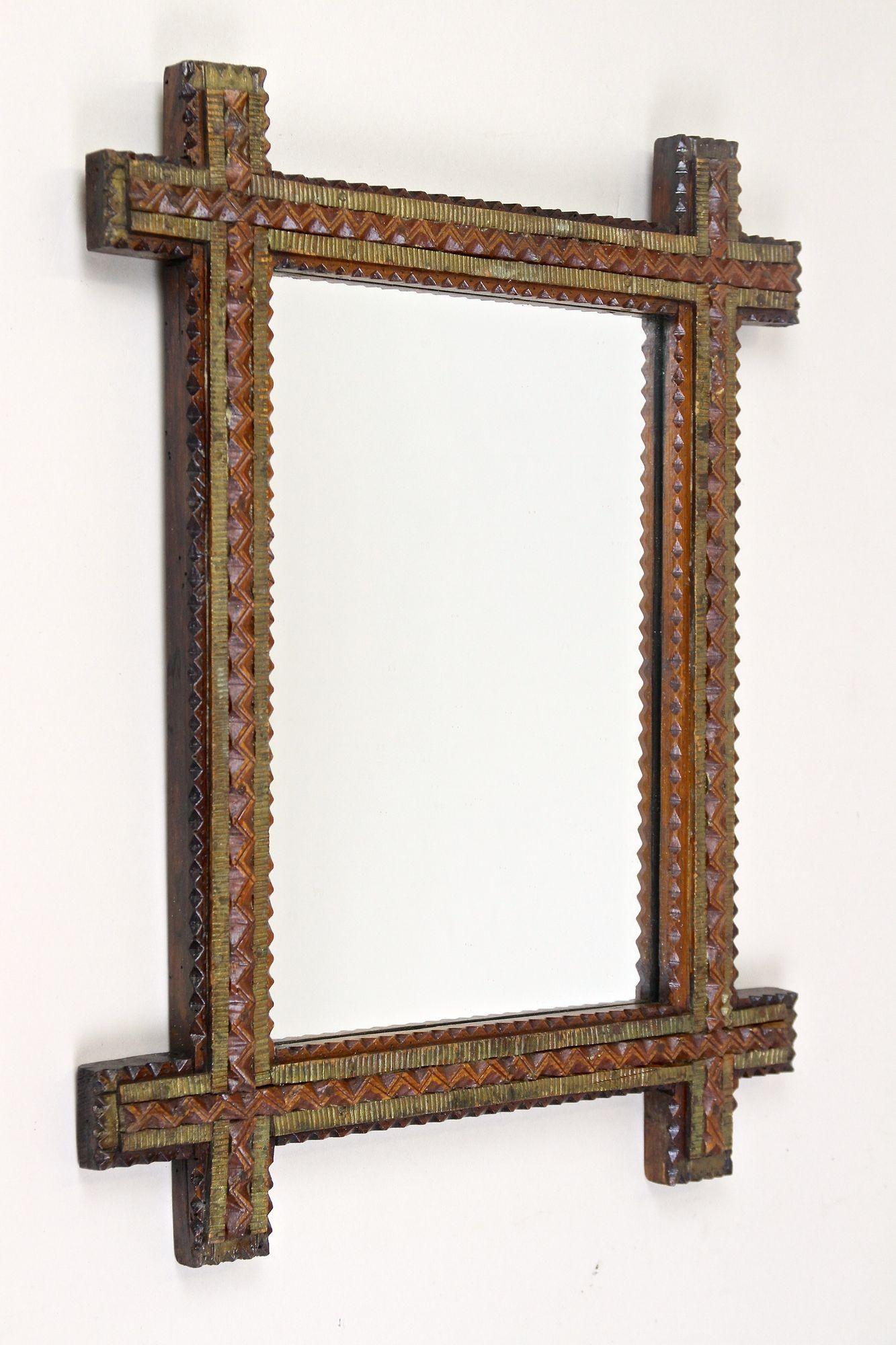 Beautiful crafted late 19th century Tramp Art mirror out of Austria. Elaborately made around 1870, this small rustic mirror impresses with its different artfully hand-carved bars. An absolute design highlight is the great idea of using various