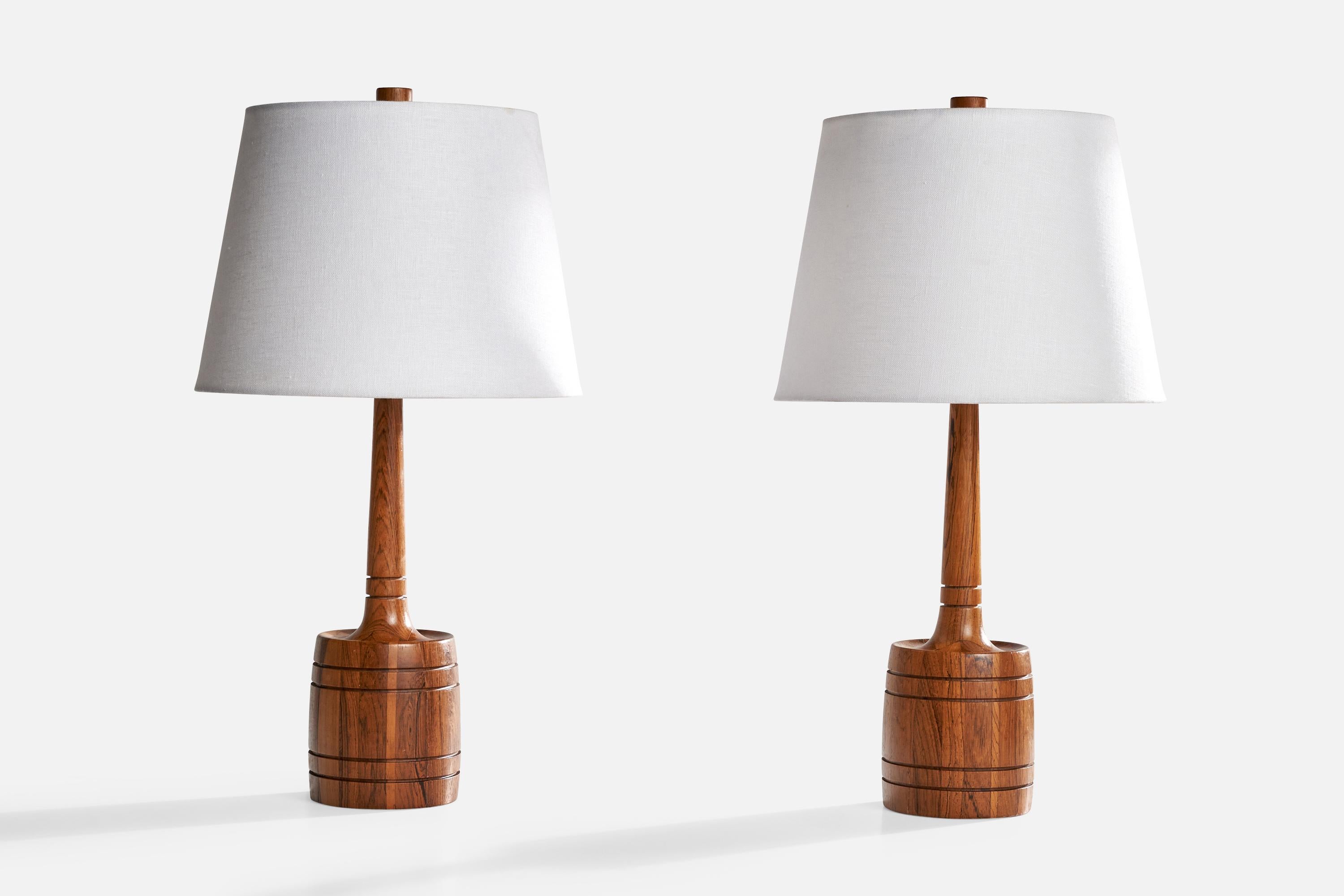 A pair of rosewood table lamps produced by Tranås Stilarmatur, Sweden, c. 1960s.

Dimensions of Lamp (inches): 16“ H x 4.625“ Diameter

Dimensions of Shade (inches): 9“ Top Diameter x 12” Bottom Diameter x 9“ H

Dimensions of Lamp with Shade